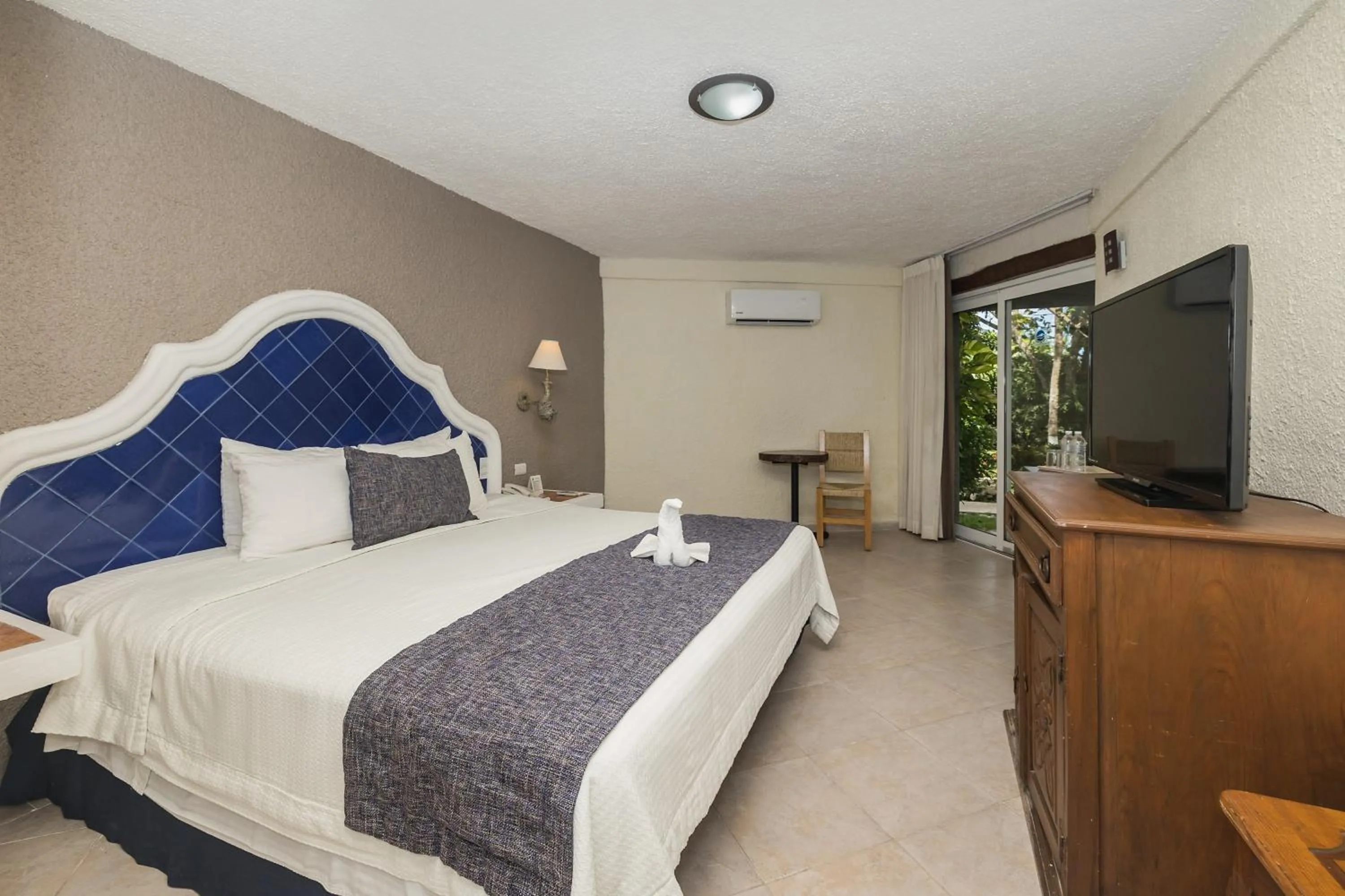 Bed in Casa del Mar Cozumel Hotel & Dive Resort with free access to an exclusive beach club