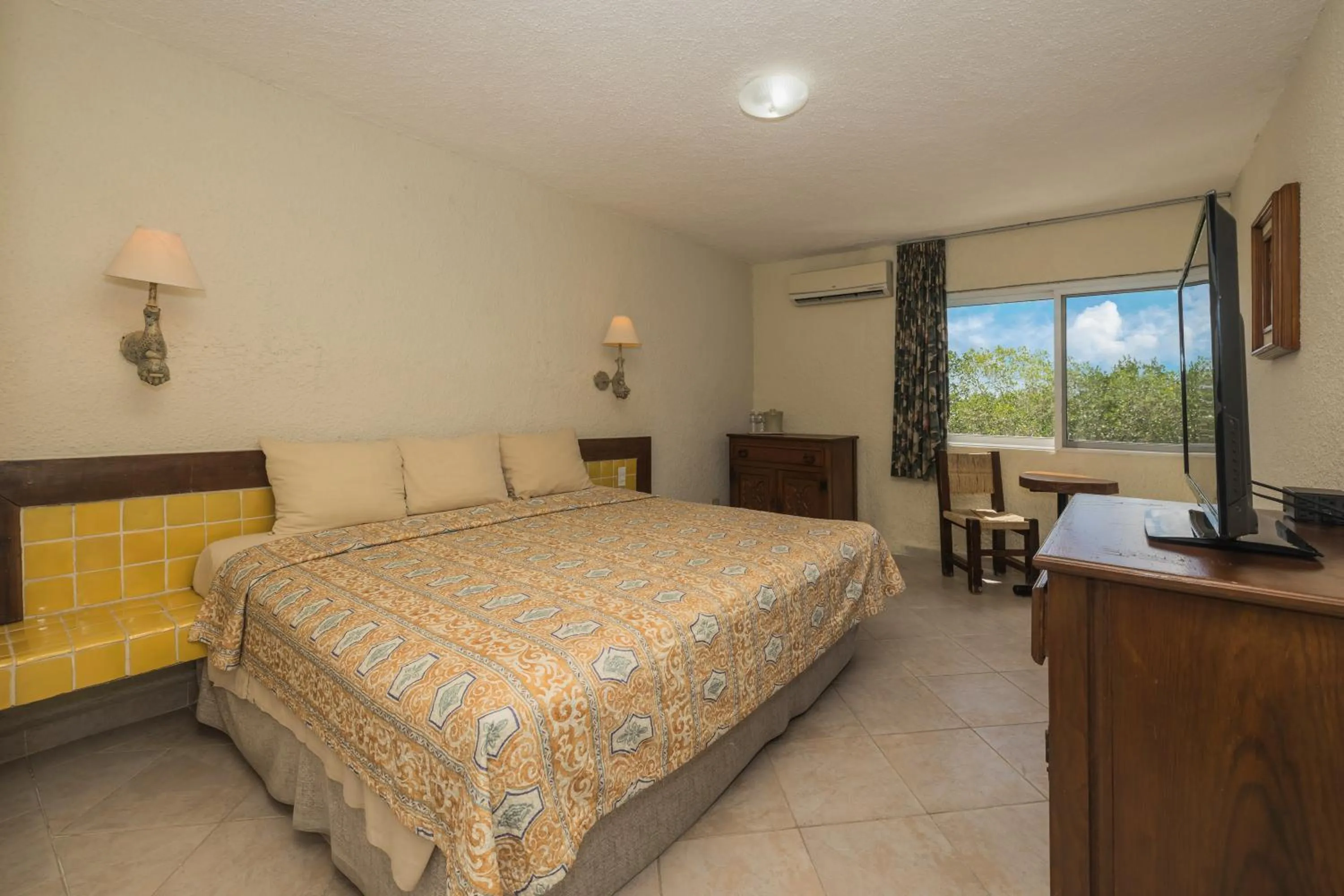 Bed in Casa del Mar Cozumel Hotel & Dive Resort with free access to an exclusive beach club