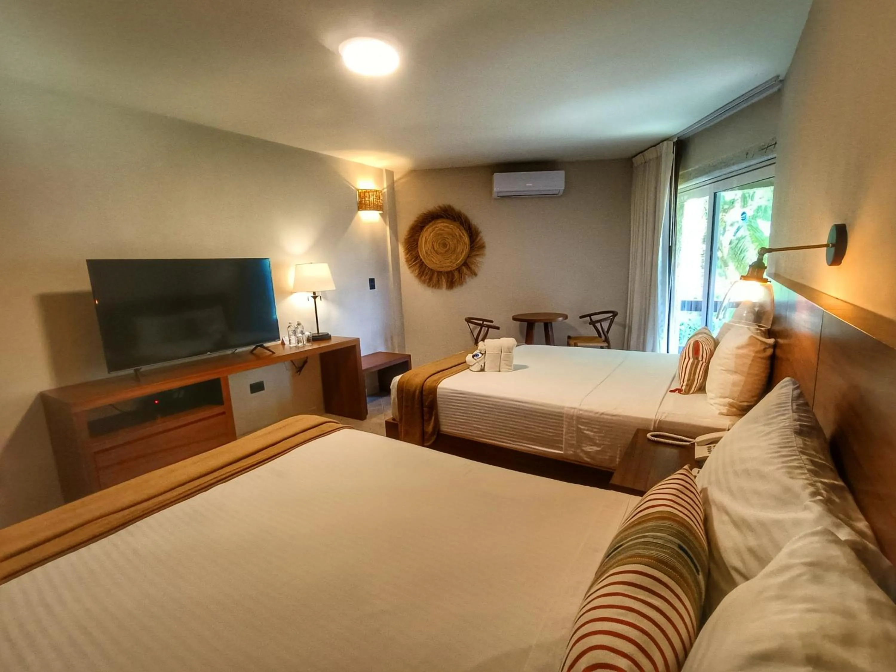 Bed in Casa del Mar Cozumel Hotel & Dive Resort with free access to an exclusive beach club