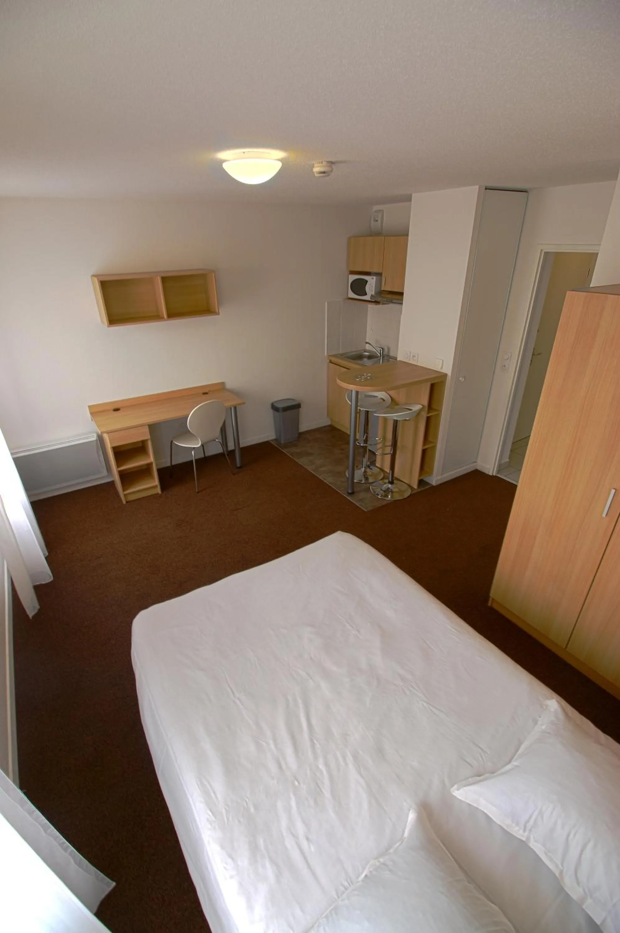 Bed in Kosy Appart Hôtel Résidence Arboréa