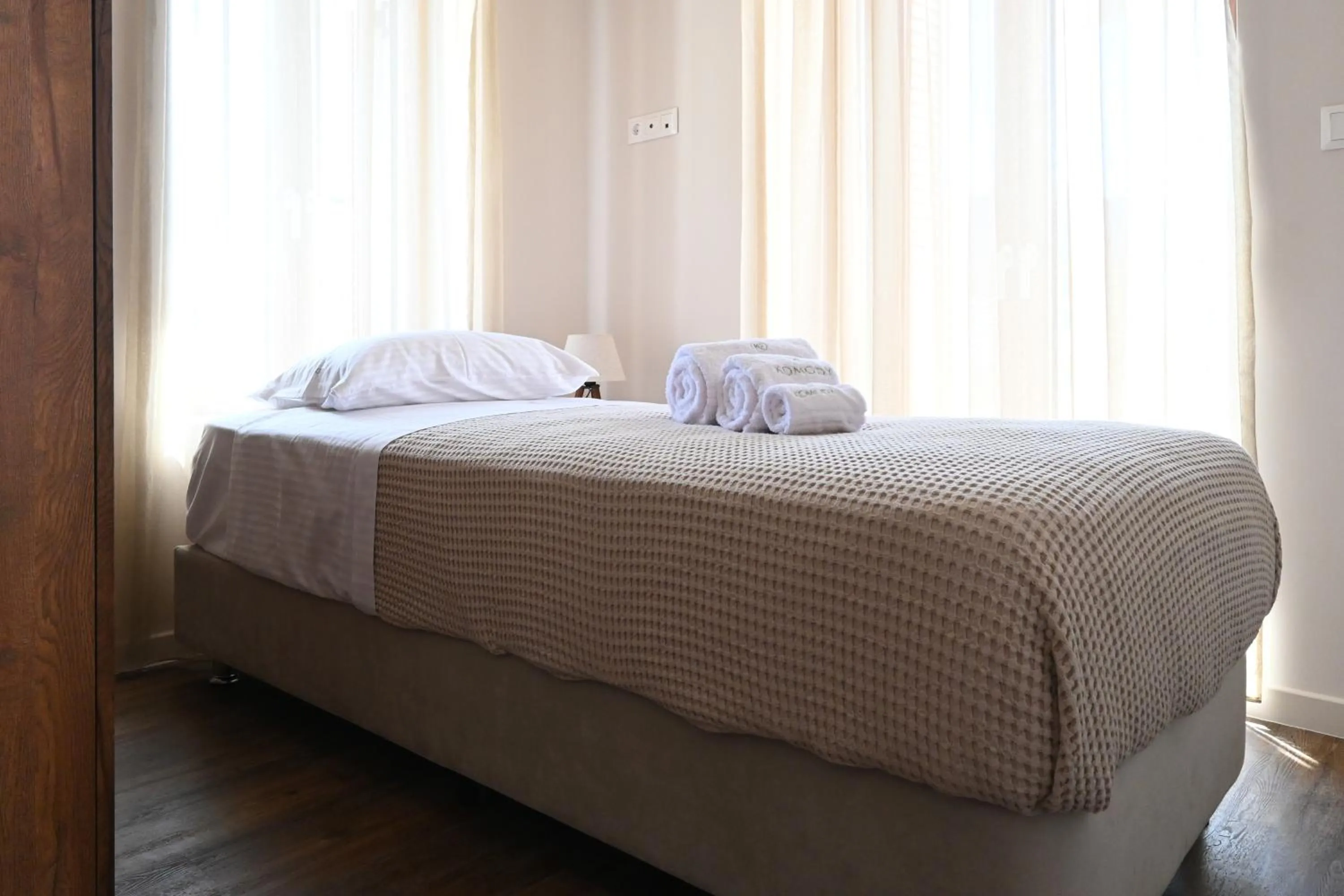 Bed in Komody Apartments