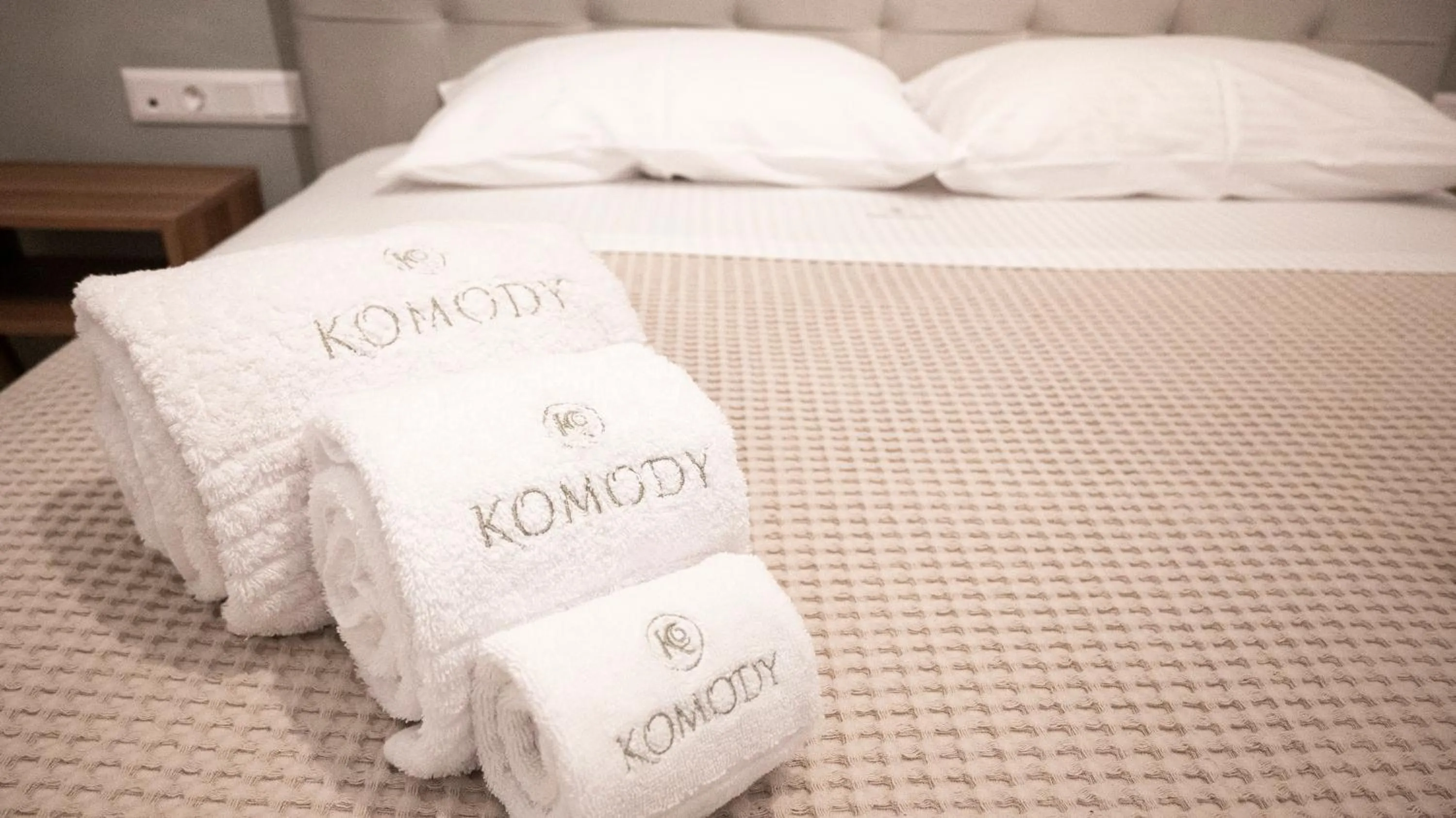 Bed in Komody Apartments