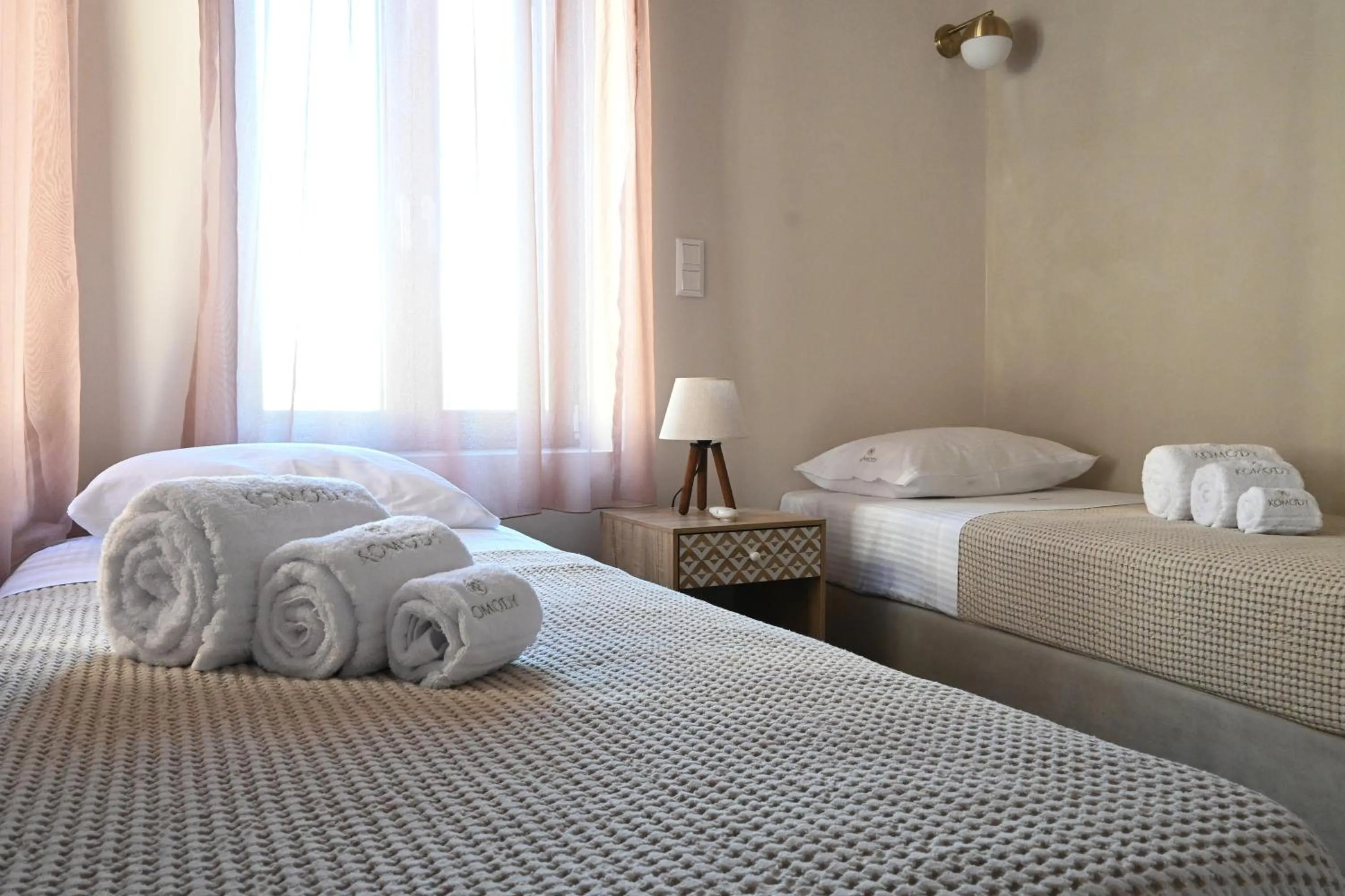 Bed in Komody Apartments