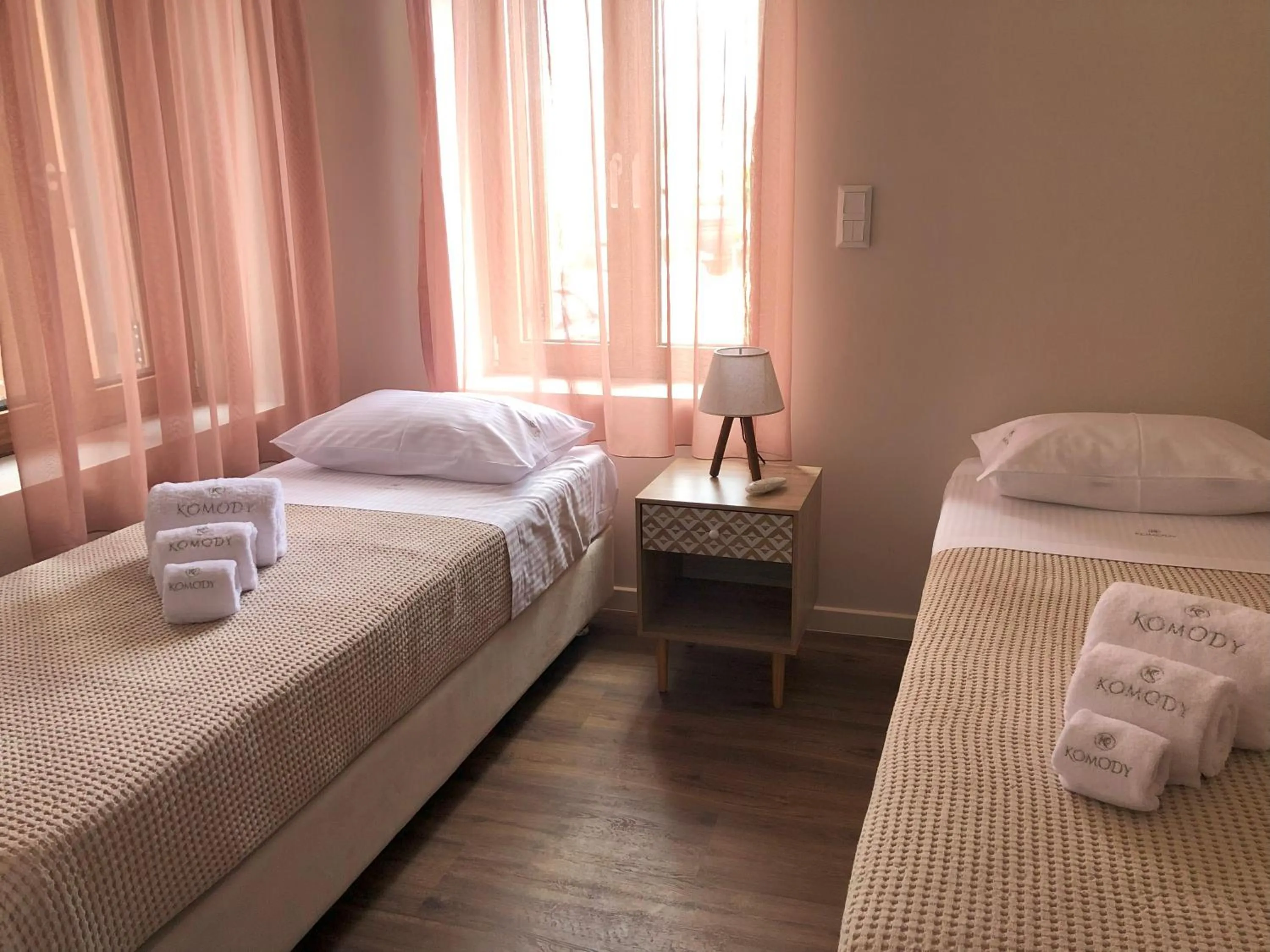 Bed in Komody Apartments