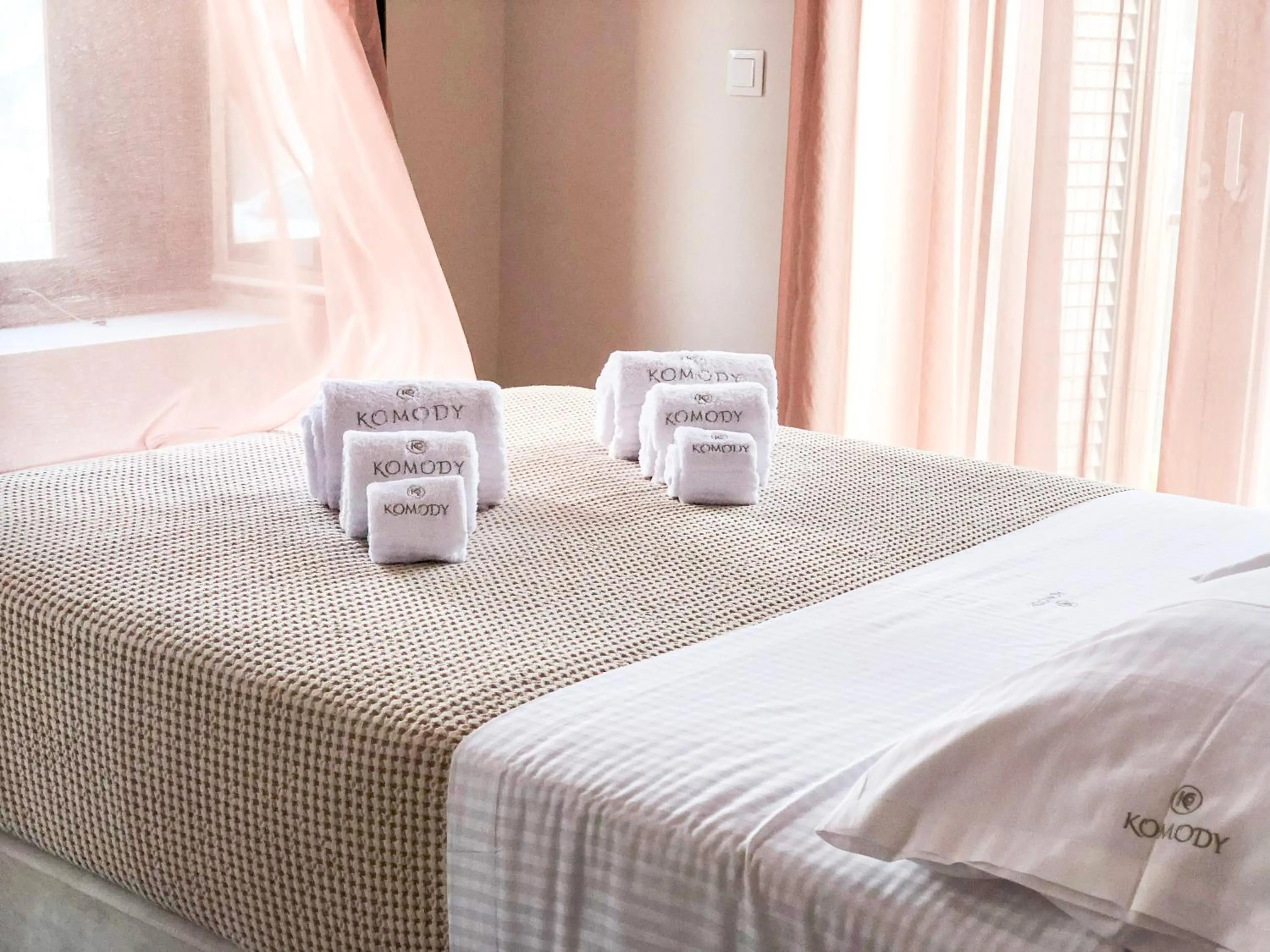 Bed in Komody Apartments