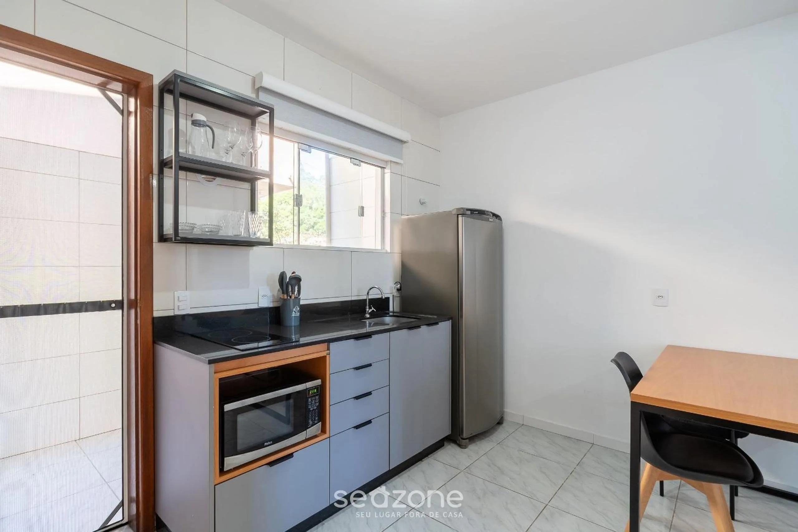 Kitchen or kitchenette in Apartamentos em Jurerê - JMA