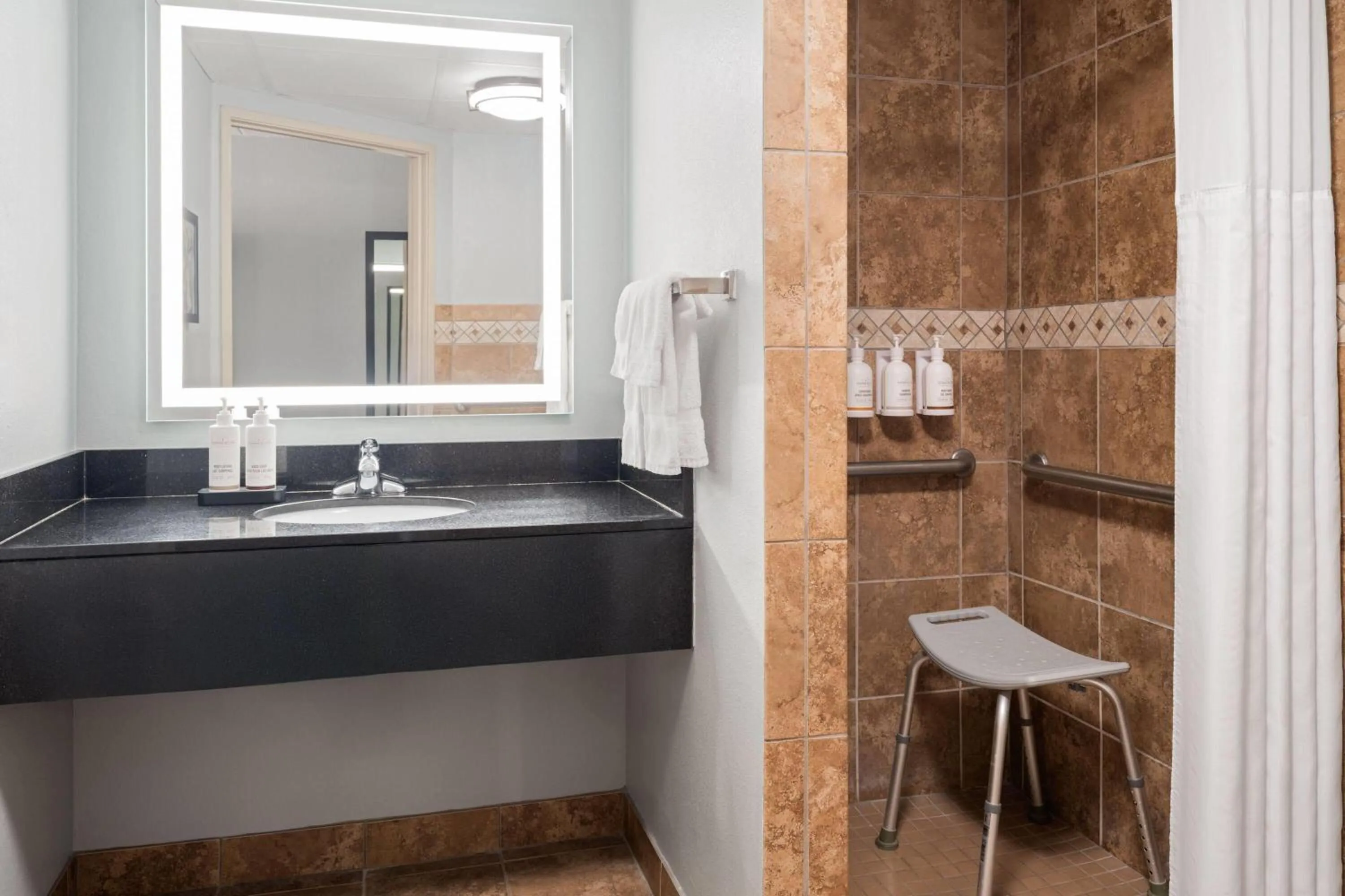 Shower in AmericInn by Wyndham Grand Forks