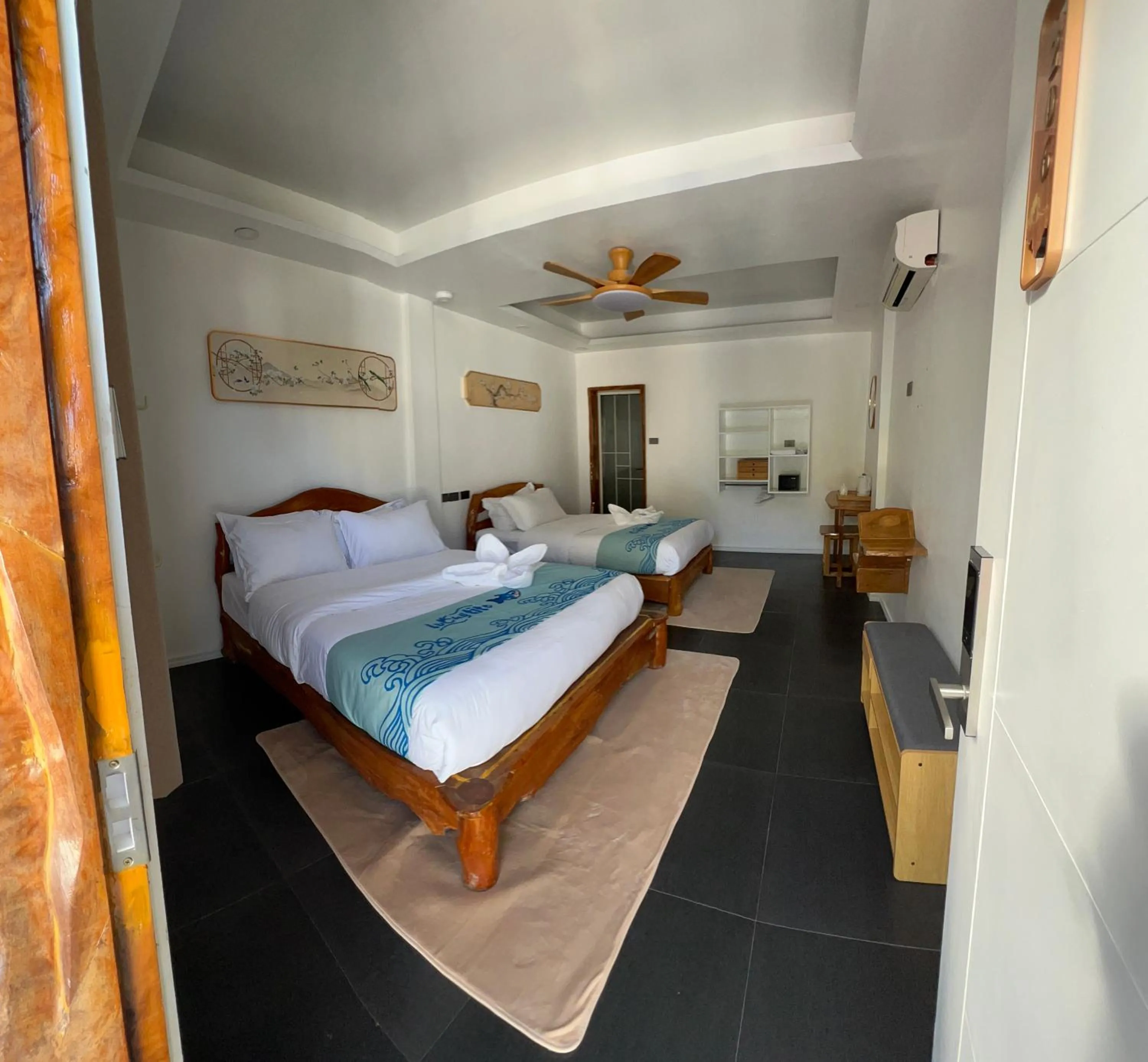 Bed in Lucky Tito PG Dive Resort