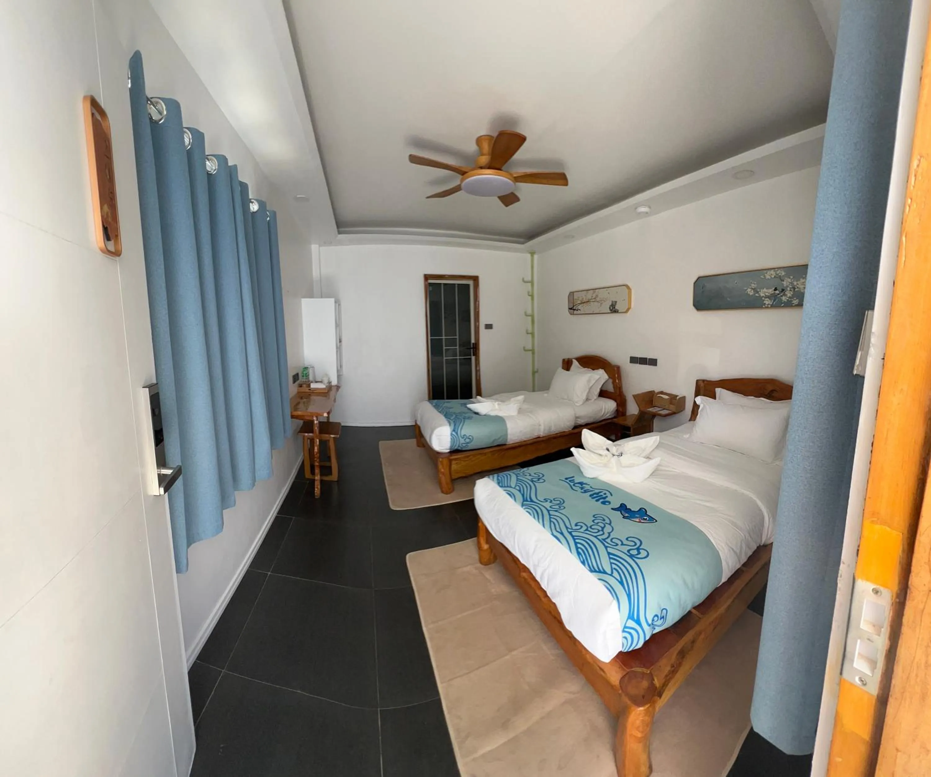 Bed in Lucky Tito PG Dive Resort