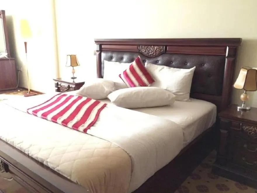 Bed in Hotel Karisimbi