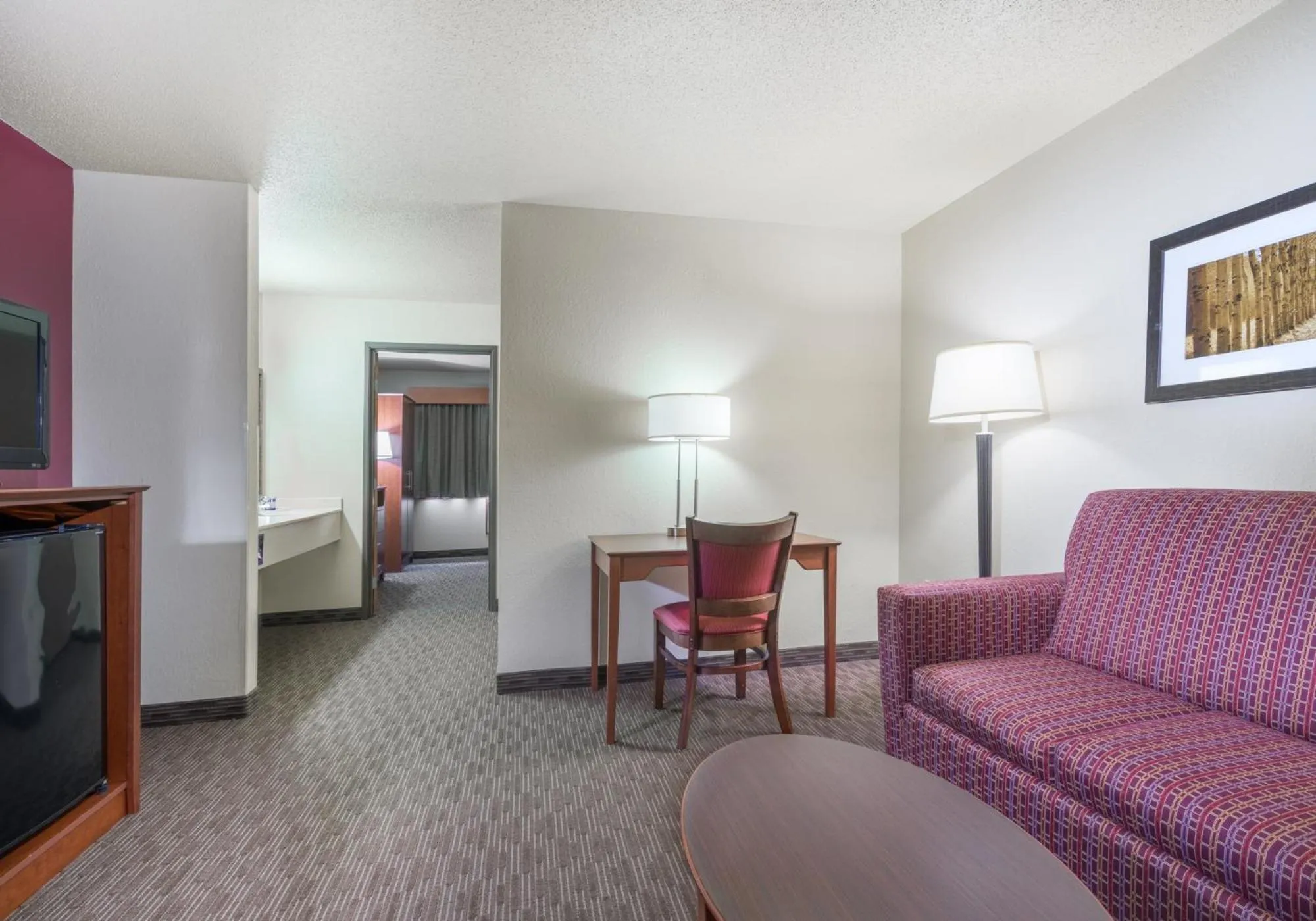 Living room, Bed in AmericInn by Wyndham Baldwin