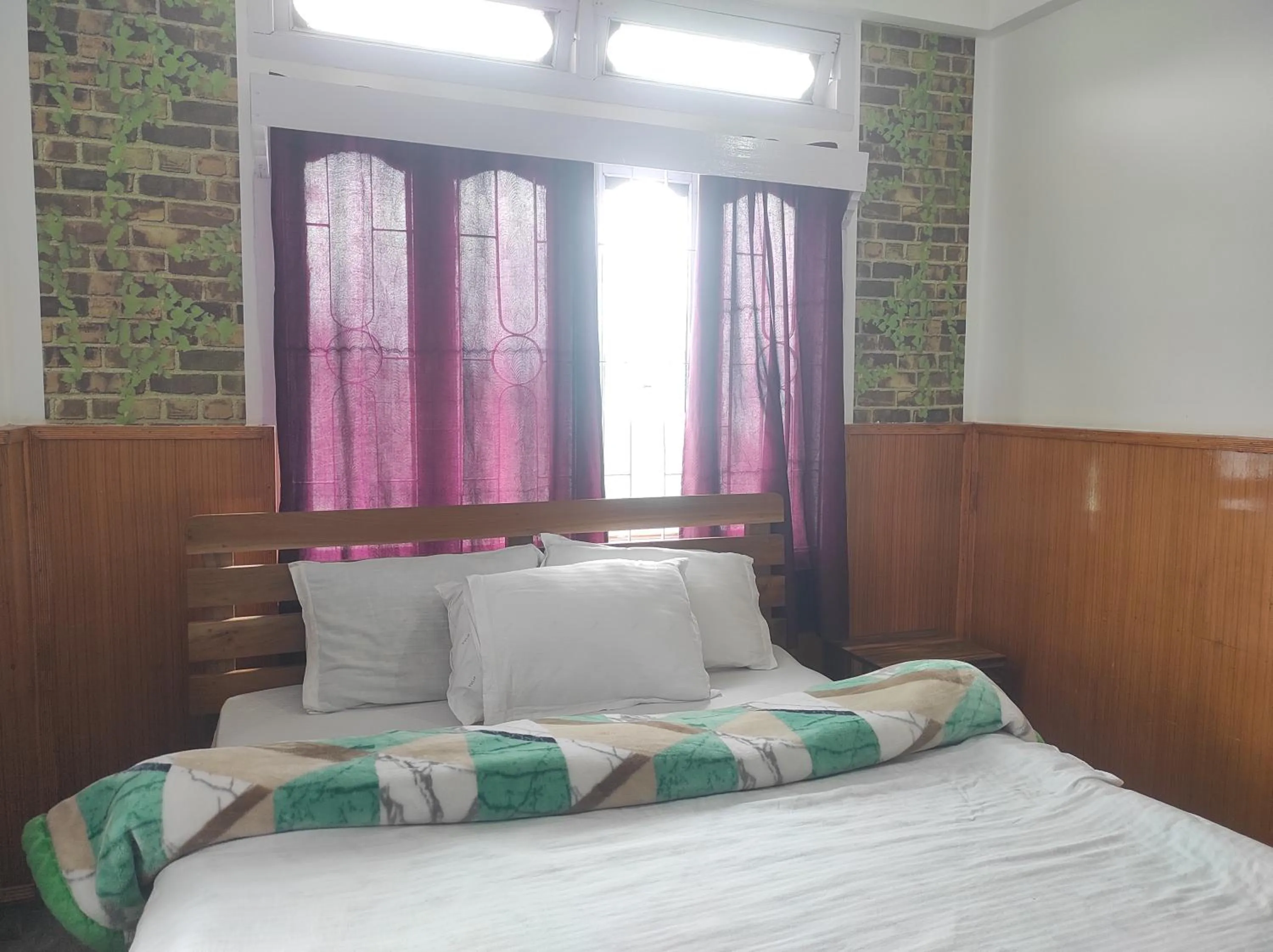 Bed in Hotel Tawang Regency