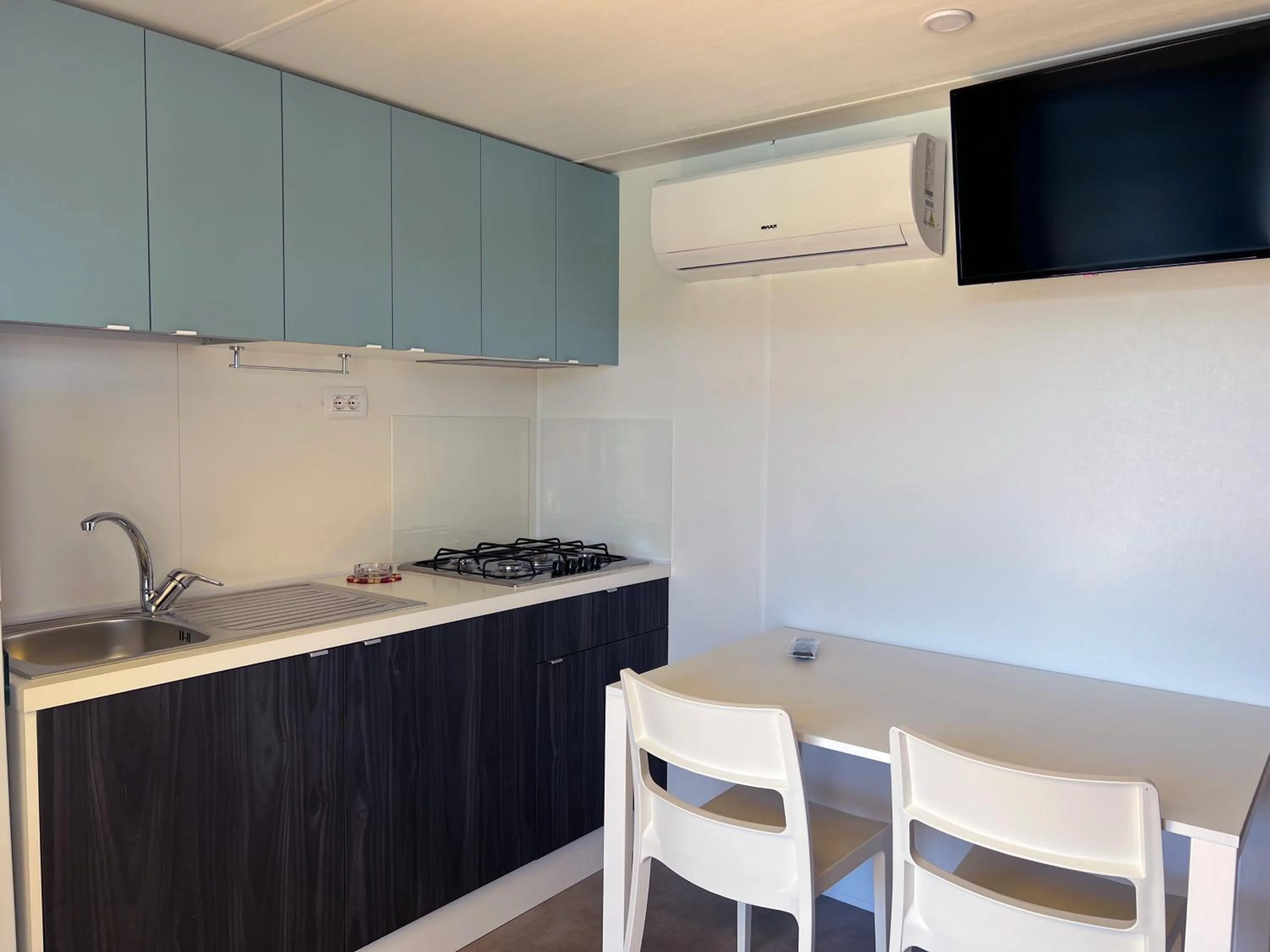 Kitchen or kitchenette in Camping Village Capo D'Orso