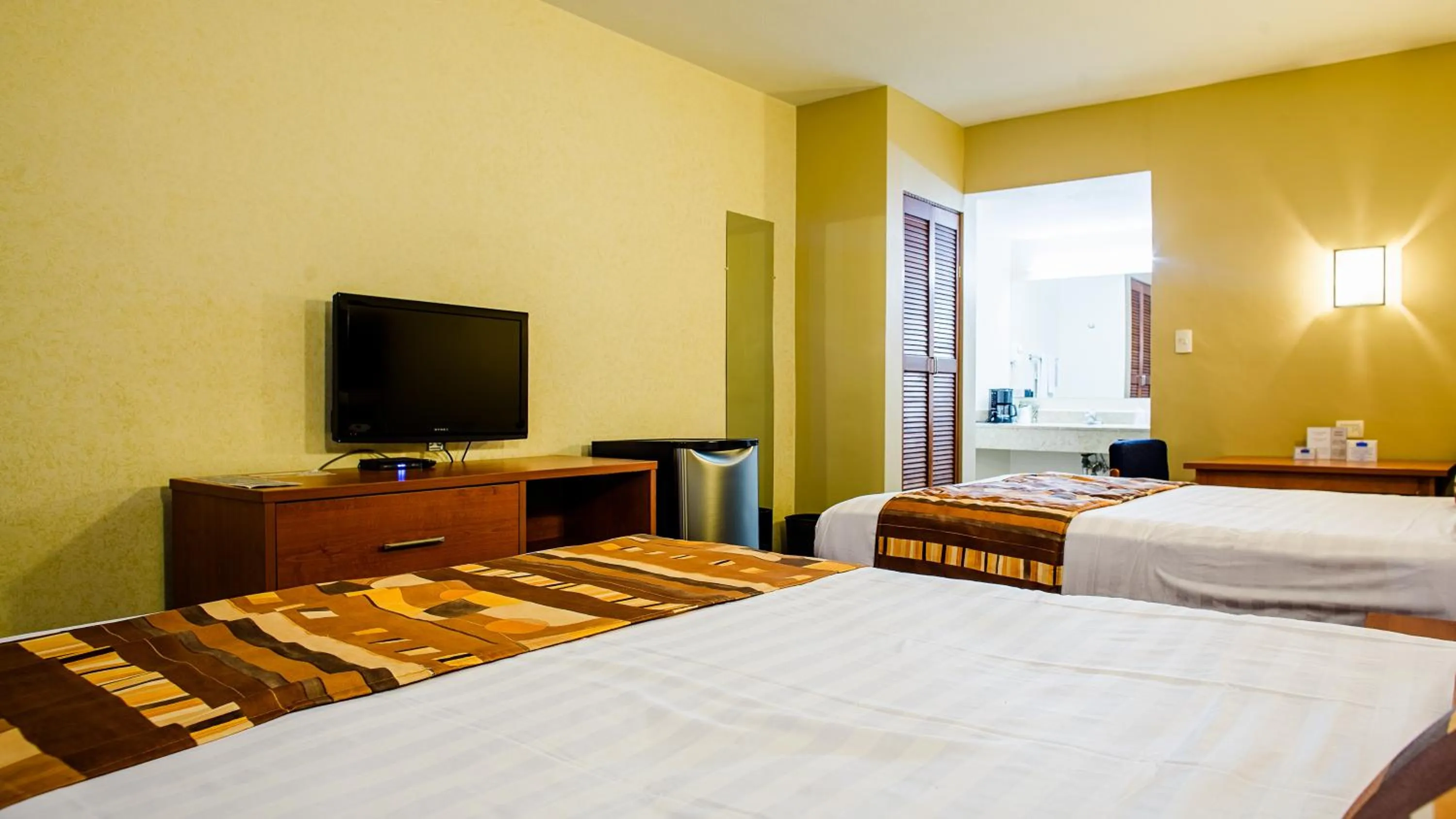 Bed in American Inn Hotel & Suites Delicias