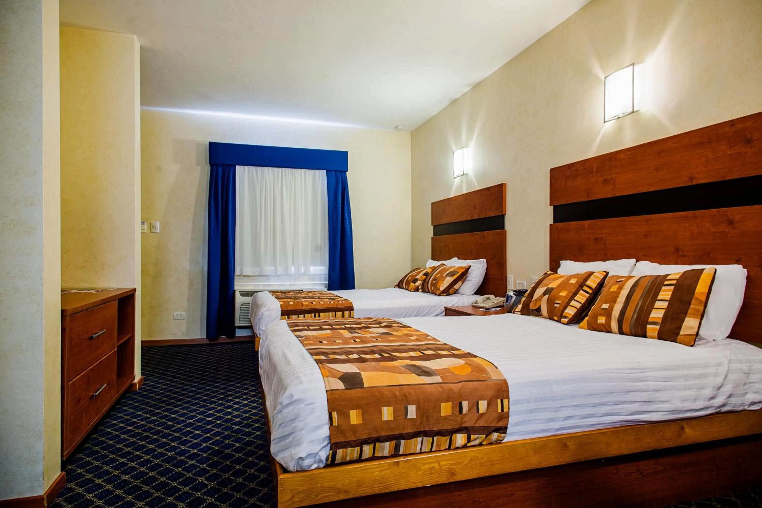 Bed in American Inn Hotel & Suites Delicias