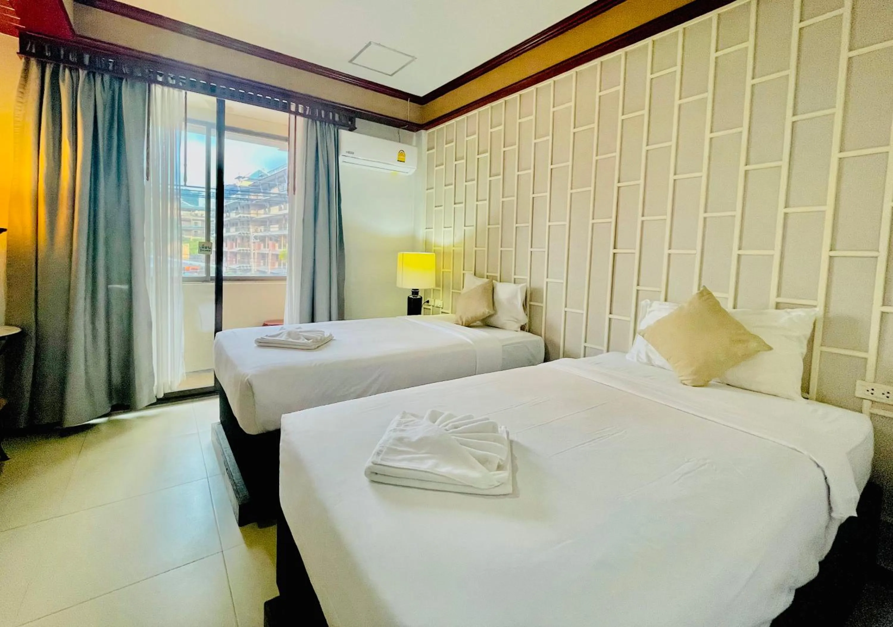 Bed in THE TOP PATONG RESORT.