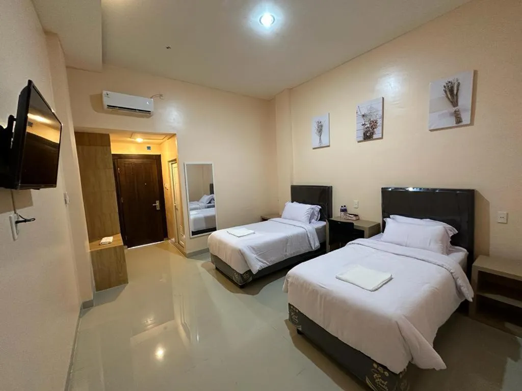 Bed in GRAND PANDAN HOTEL