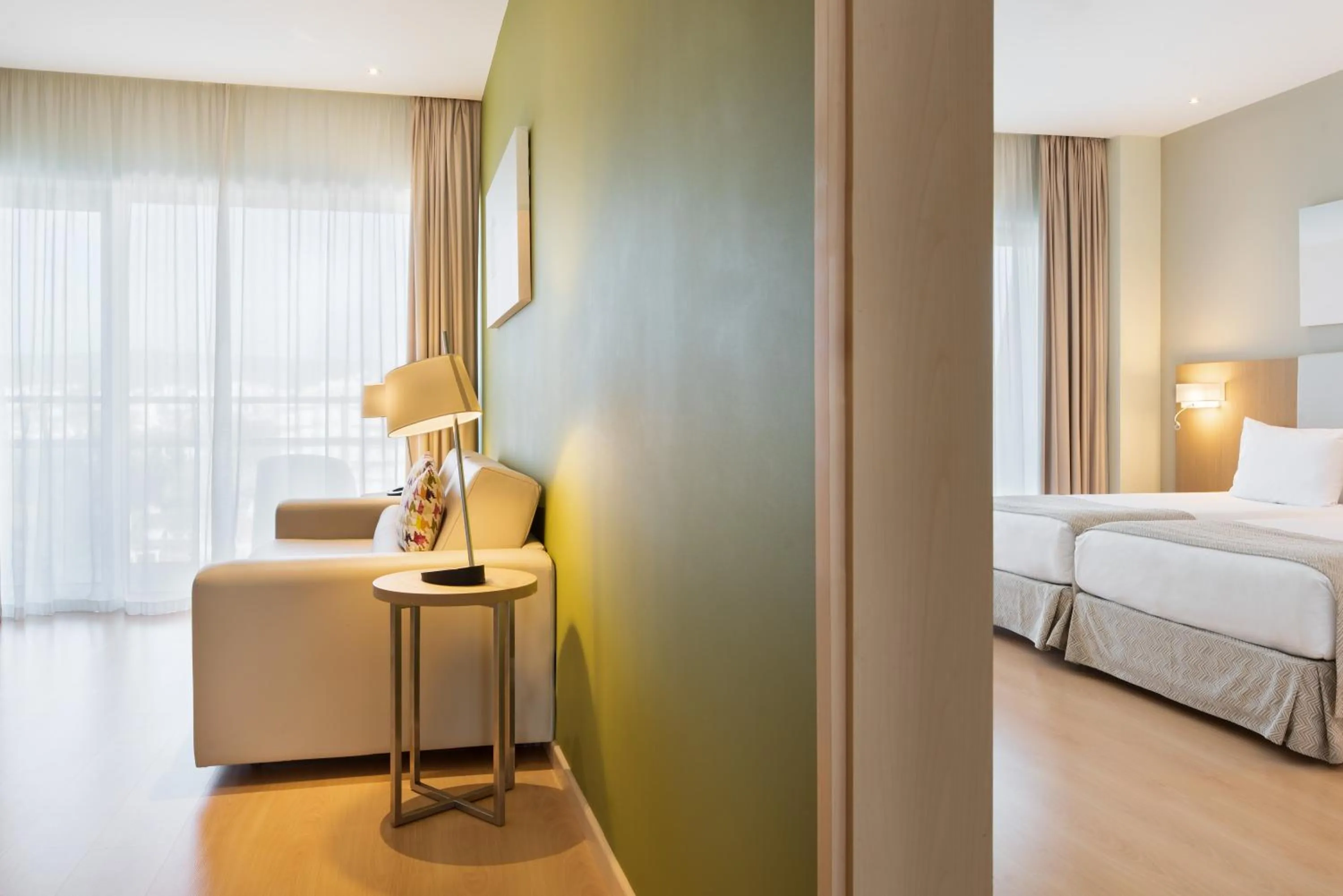 Living room, Bed in Eurostars Oasis Plaza