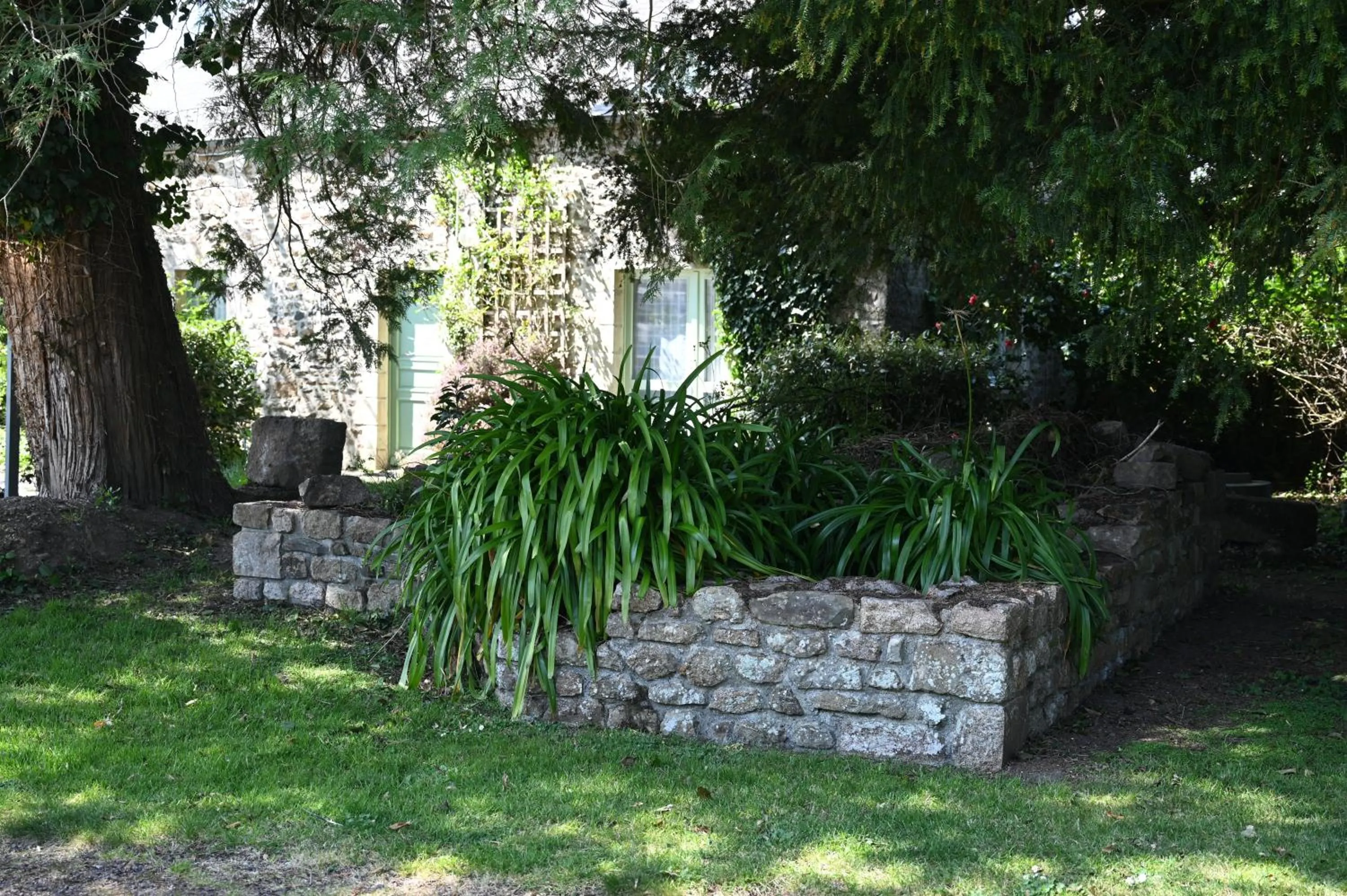 Garden in Logis Hôtel La Demeure du Perron