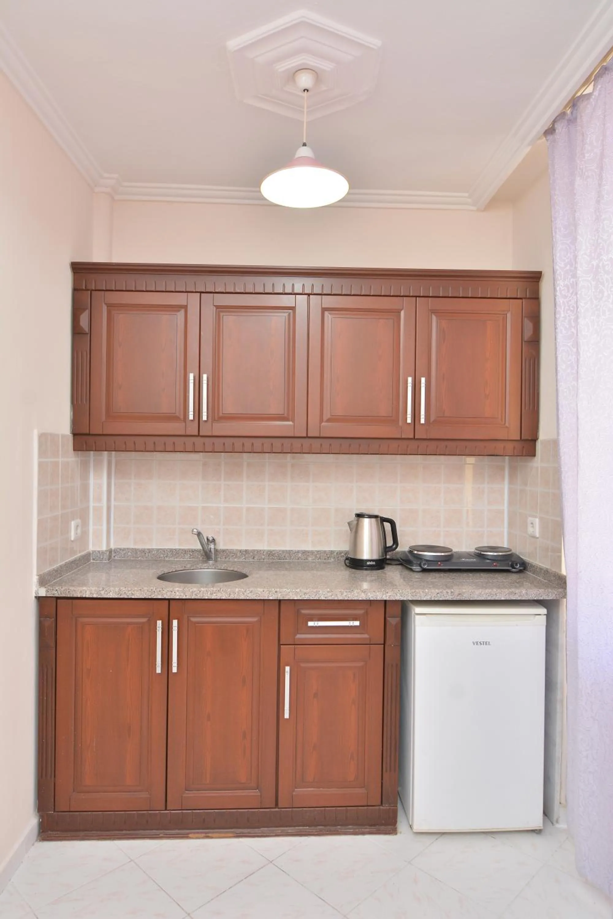 Kitchen or kitchenette in Rose Garden Apart Hotel