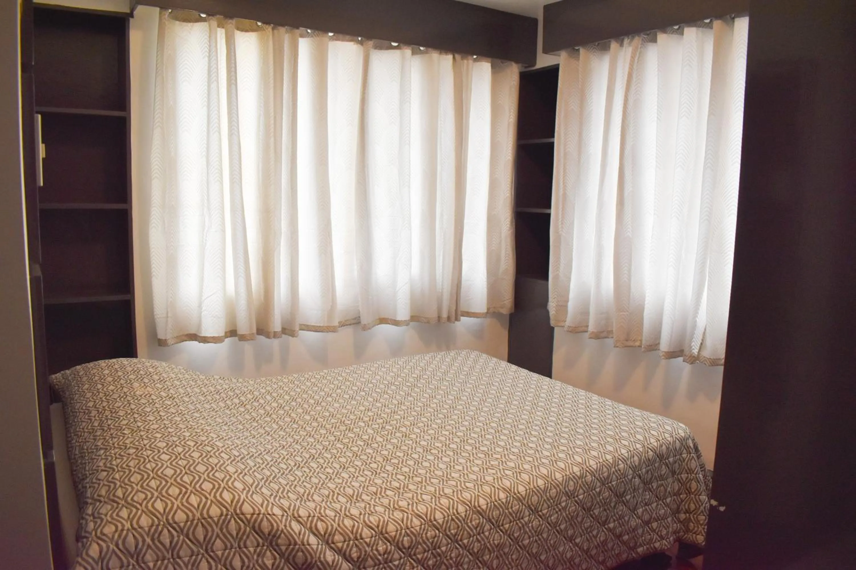 Bed in Sunette Tower Suites Makati