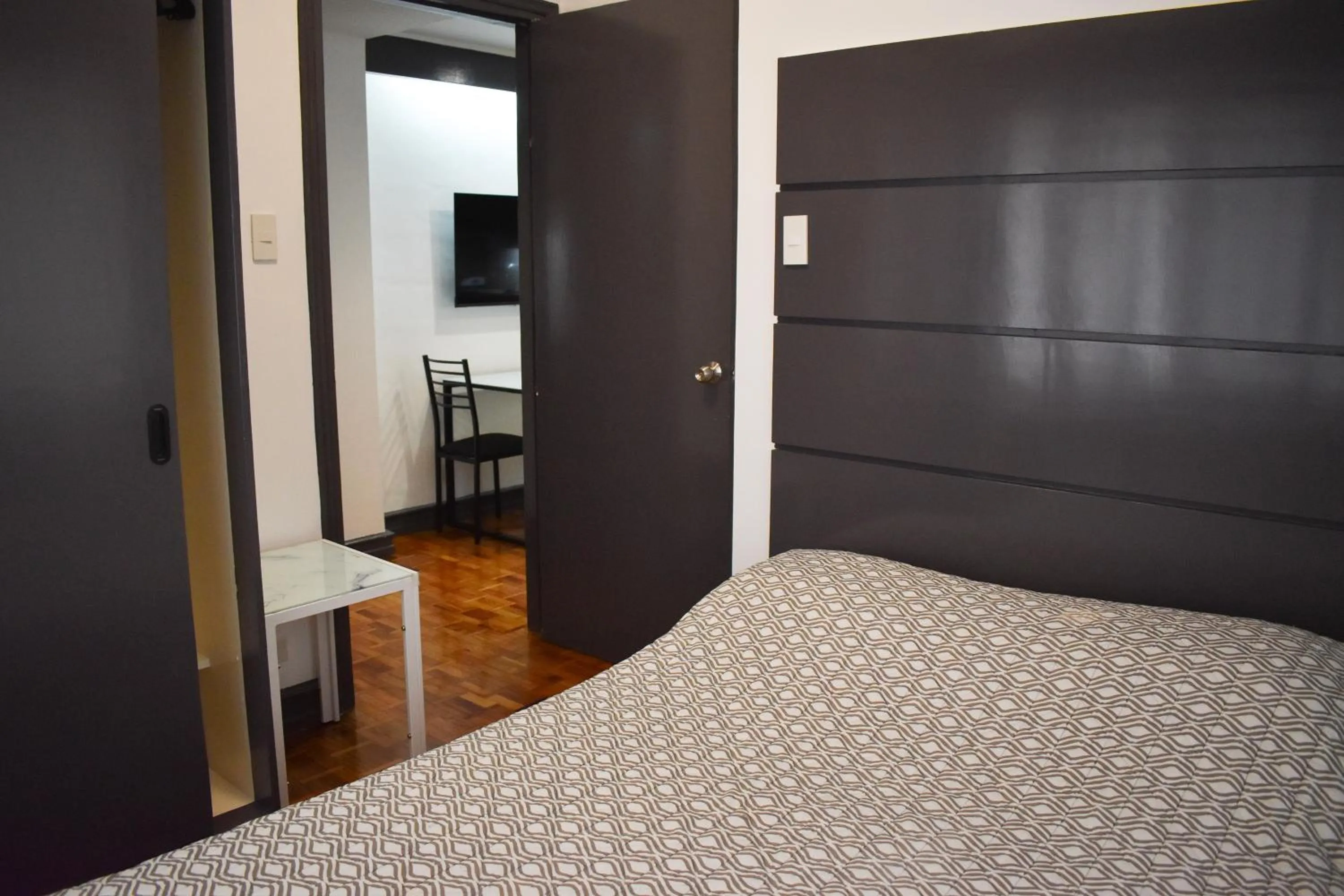 Bed in Sunette Tower Suites Makati