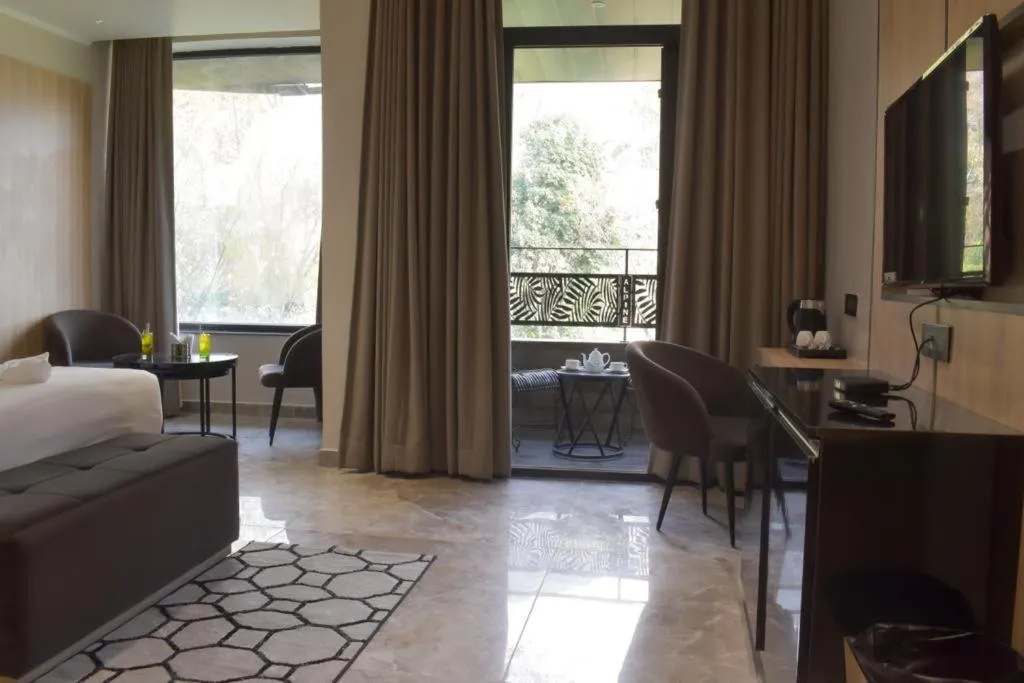 Living room, Bed in Alpine hotel and villas