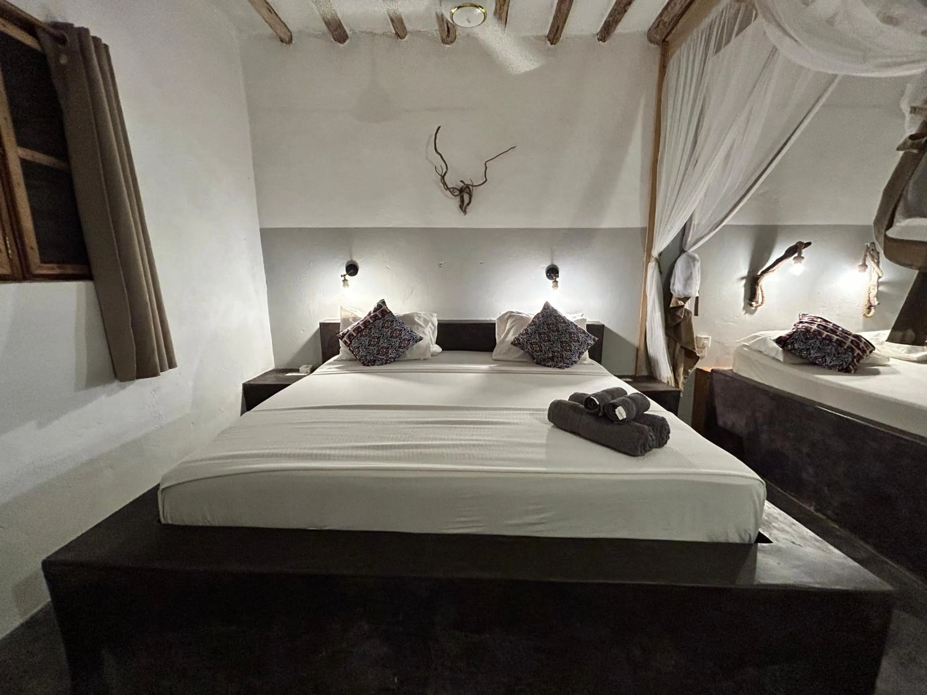 Bed in Bahari Beach Bungalows