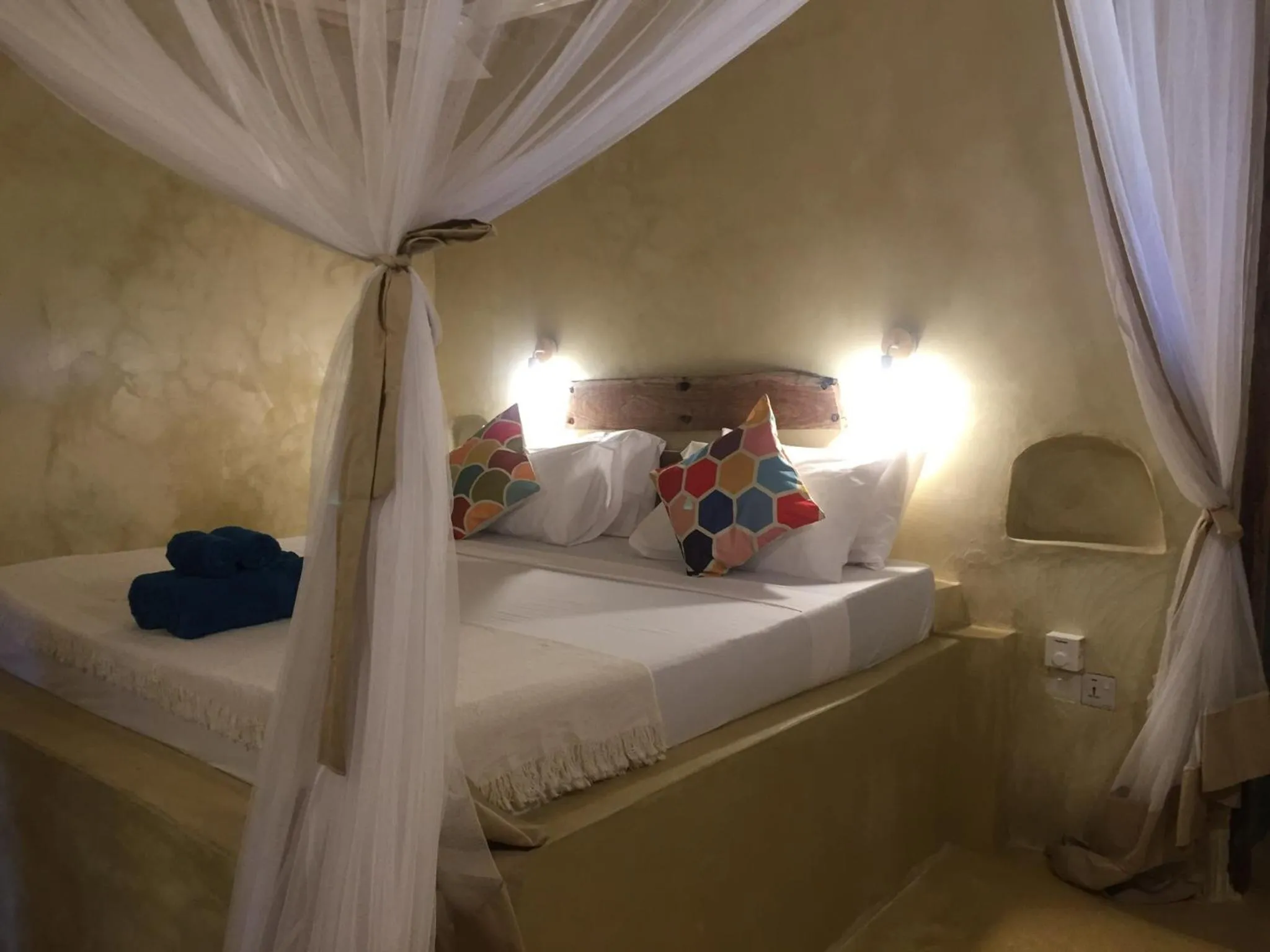 Bed in Bahari Beach Bungalows