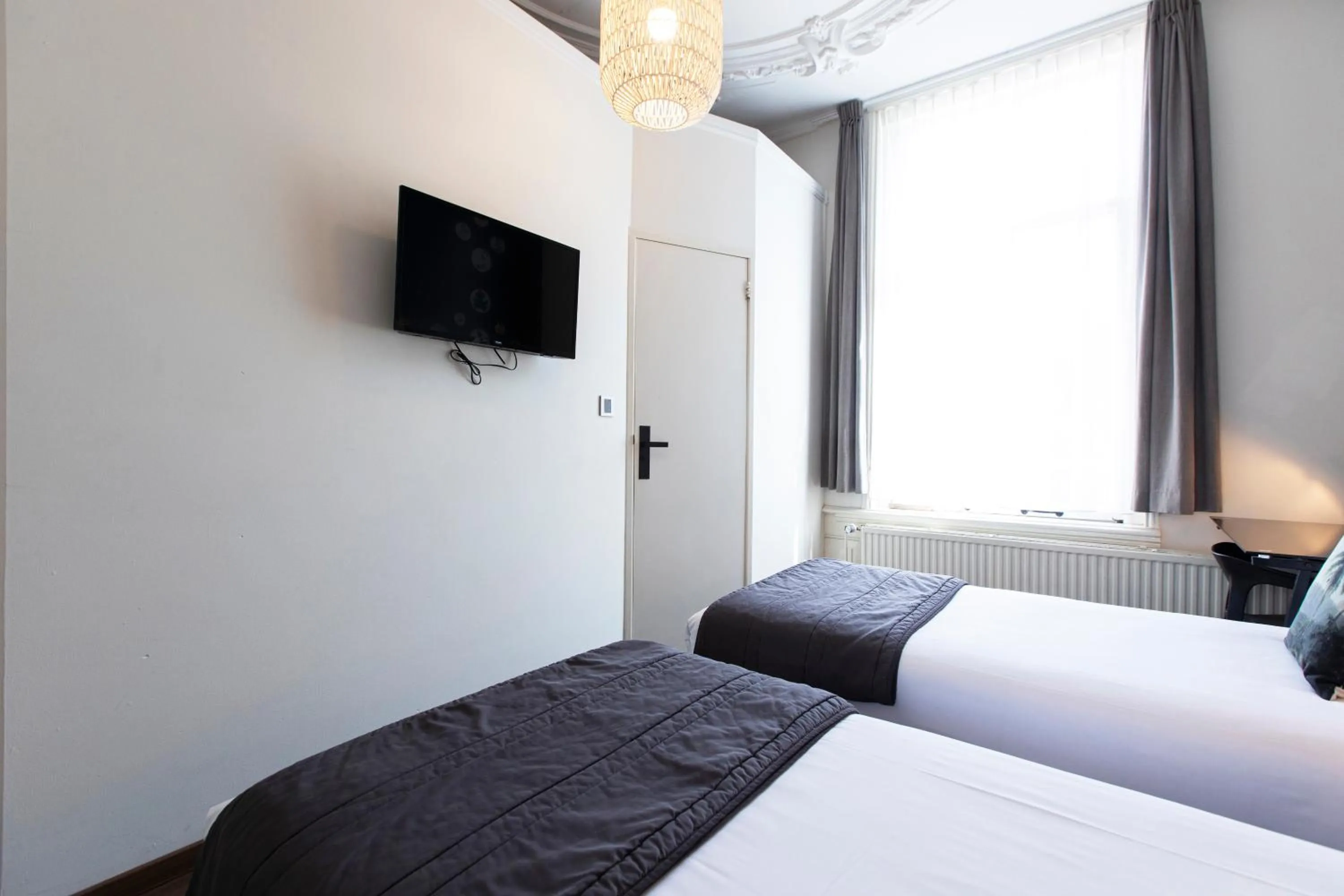 Bed in Quentin Amsterdam Hotel