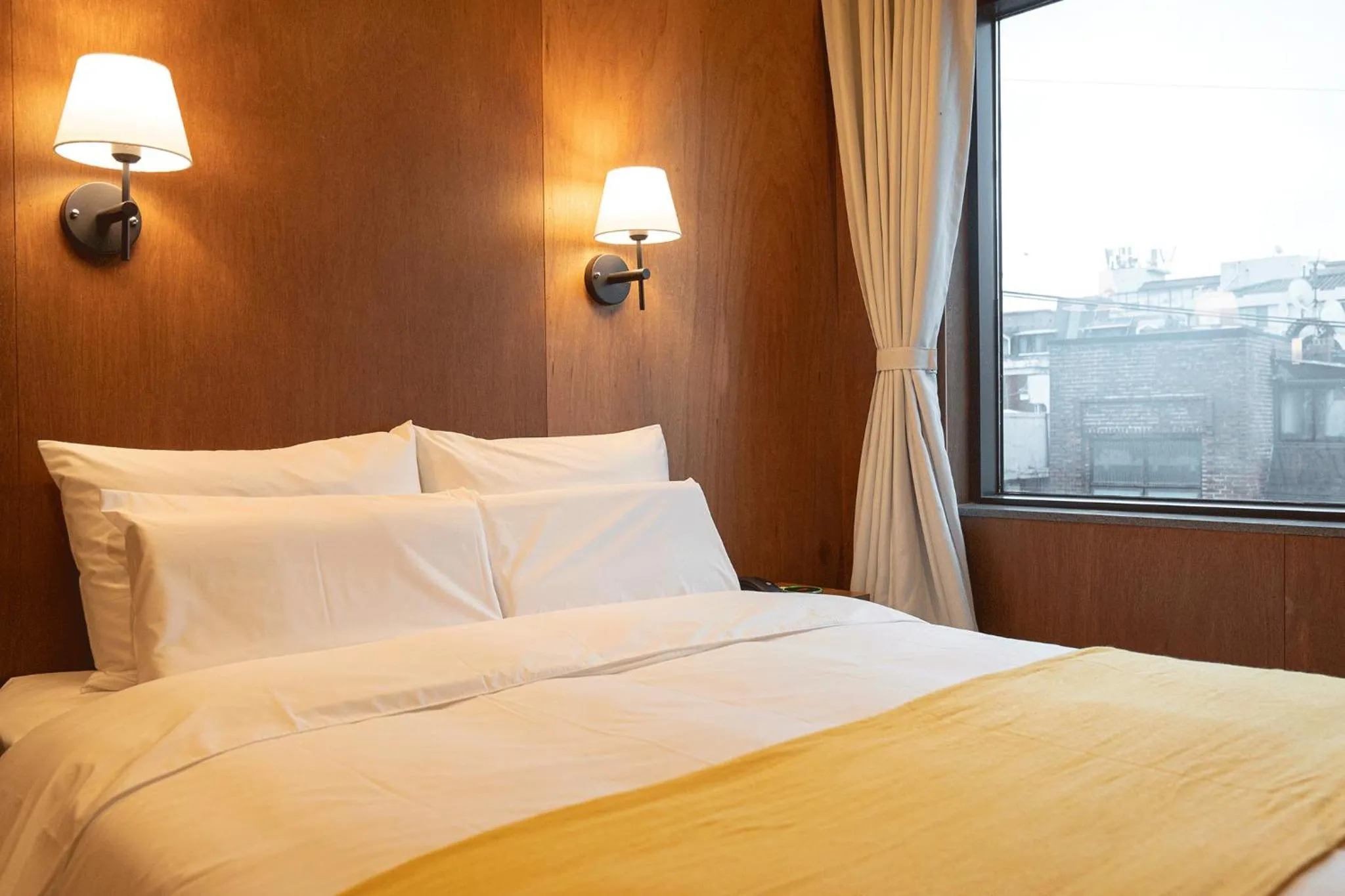 Bed in Nouvelle Hotel Seoul Itaewon by Aank