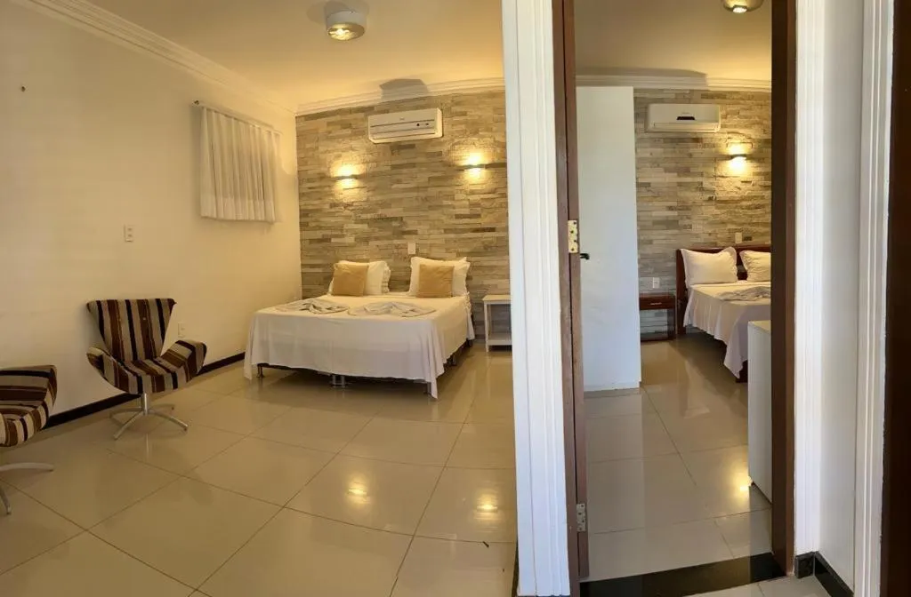 Bed in Pousada Refúgio Jardim de Canoa by Borboleta