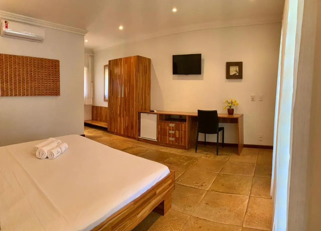 Bed in Pousada Refúgio Jardim de Canoa by Borboleta