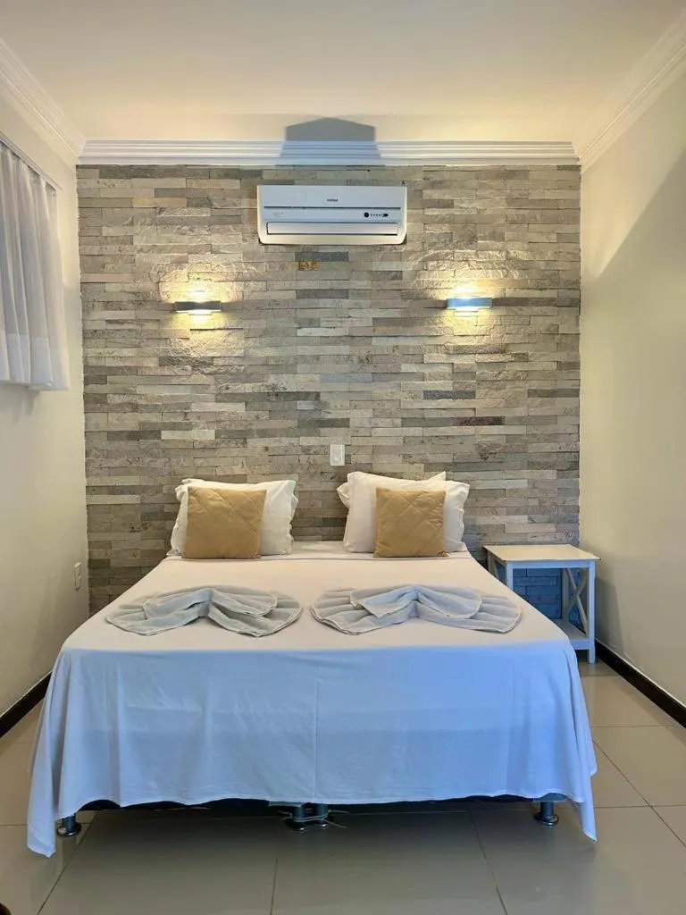 Bed in Pousada Refúgio Jardim de Canoa by Borboleta