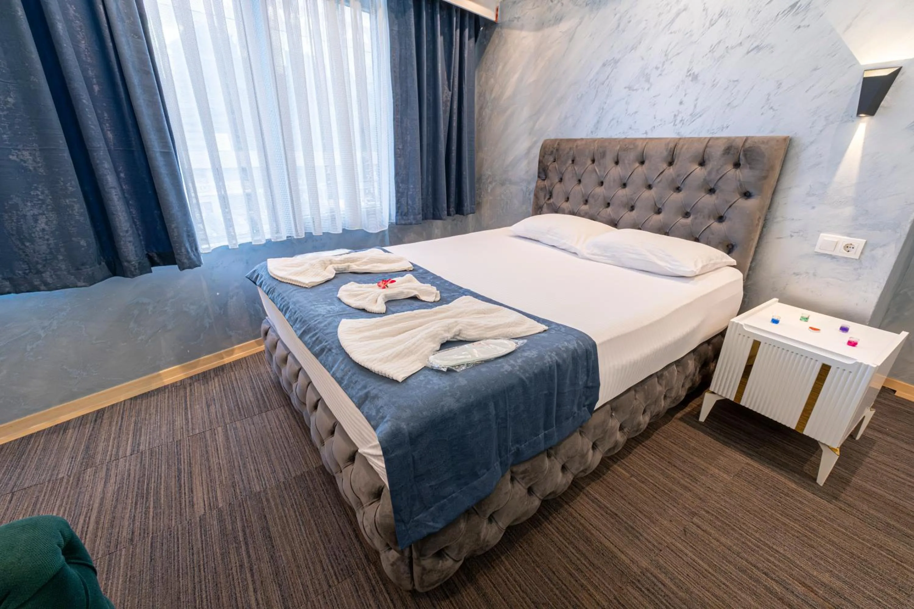 Bed in Stay Suite Hotel