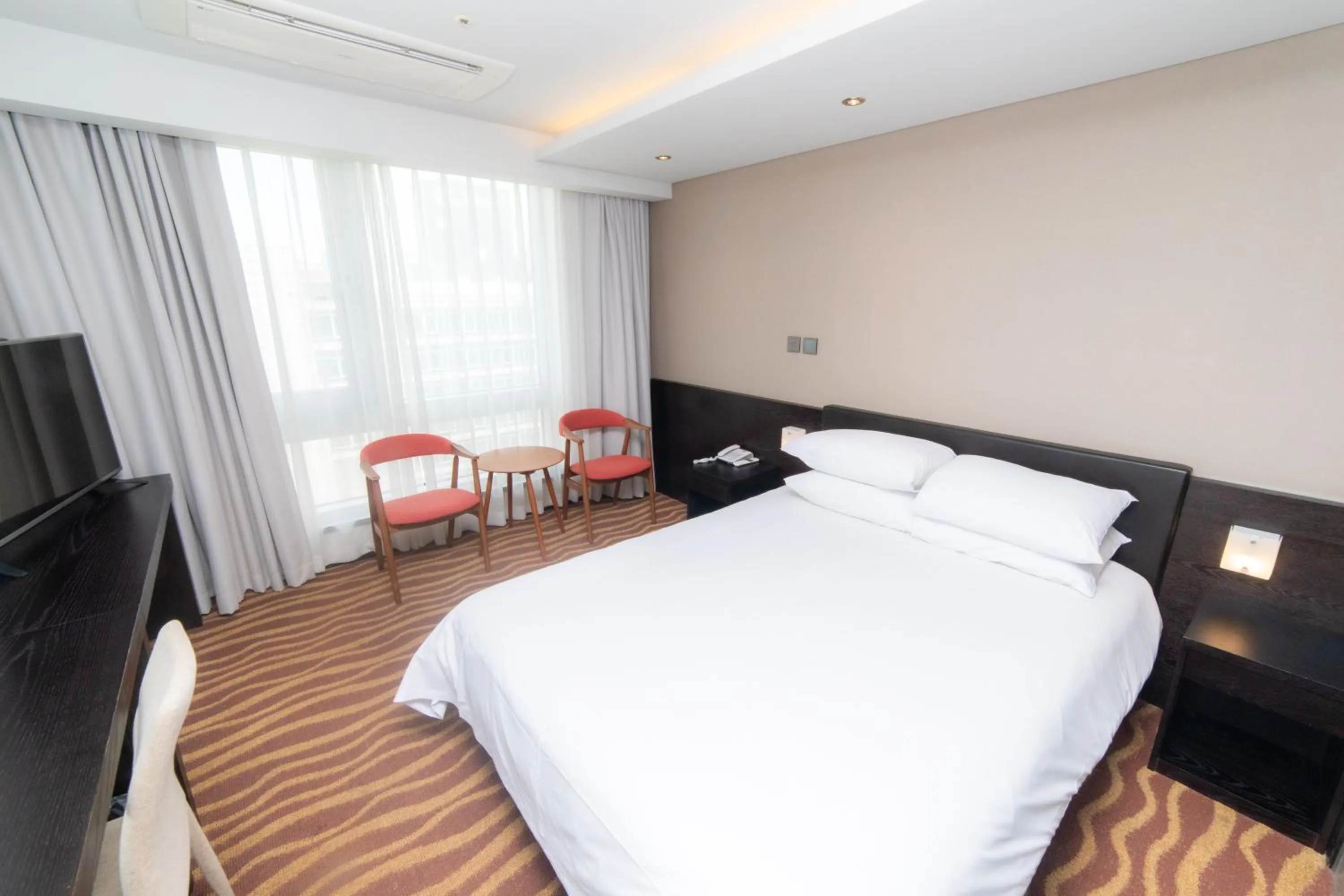 Bed in J-Grand Hotel