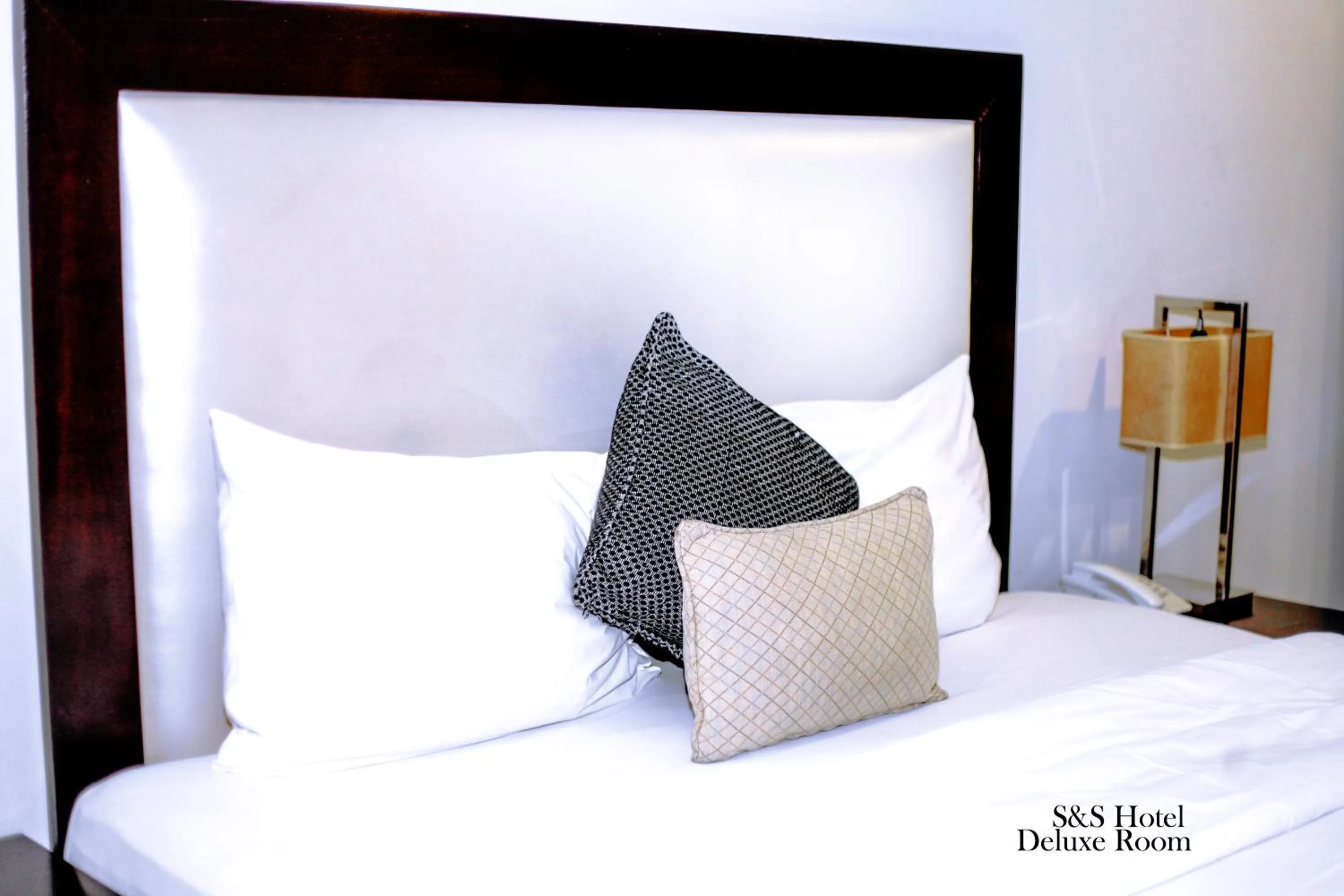 Bed in S & S Hotel & Suites