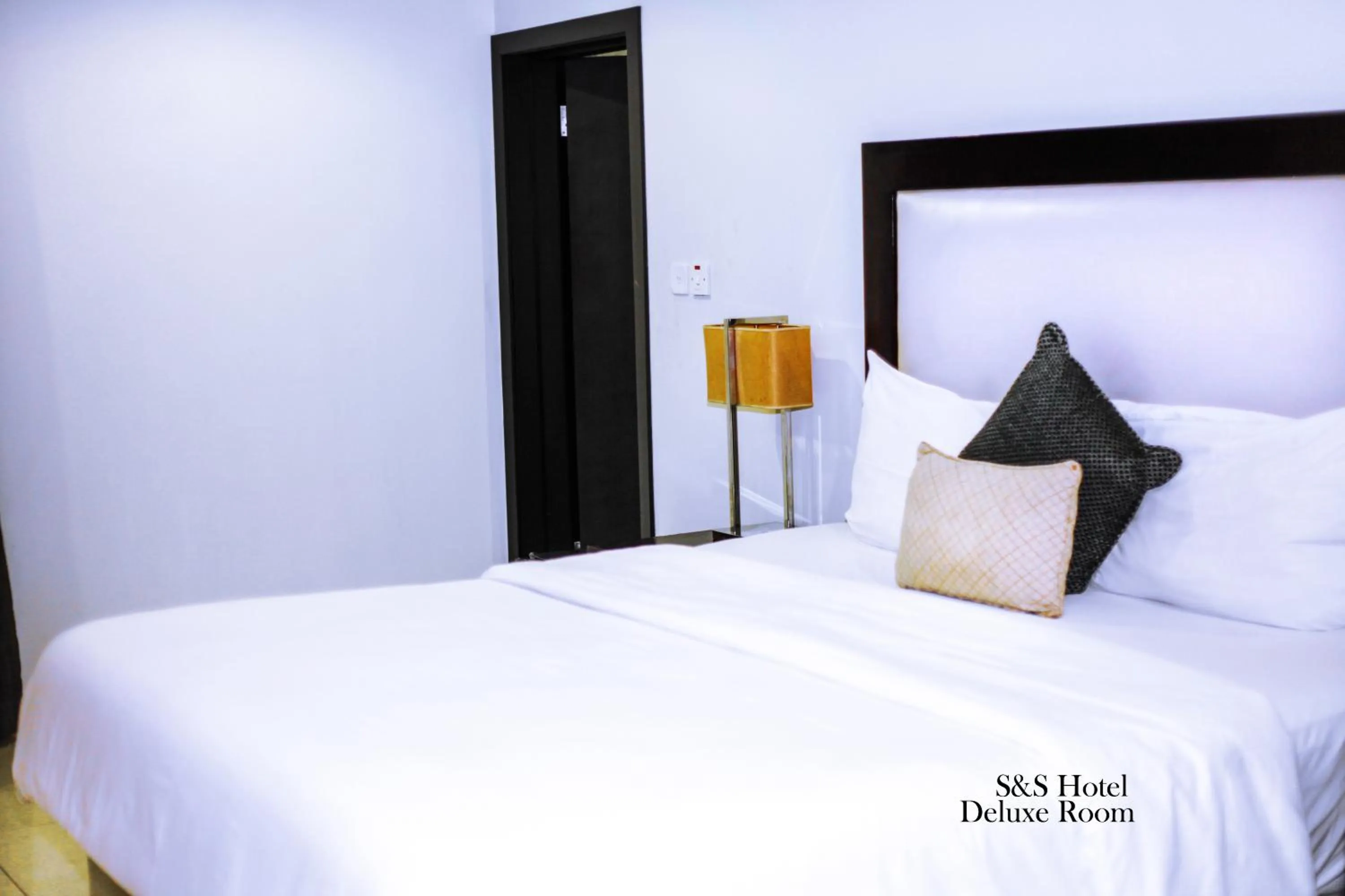Bed in S & S Hotel & Suites