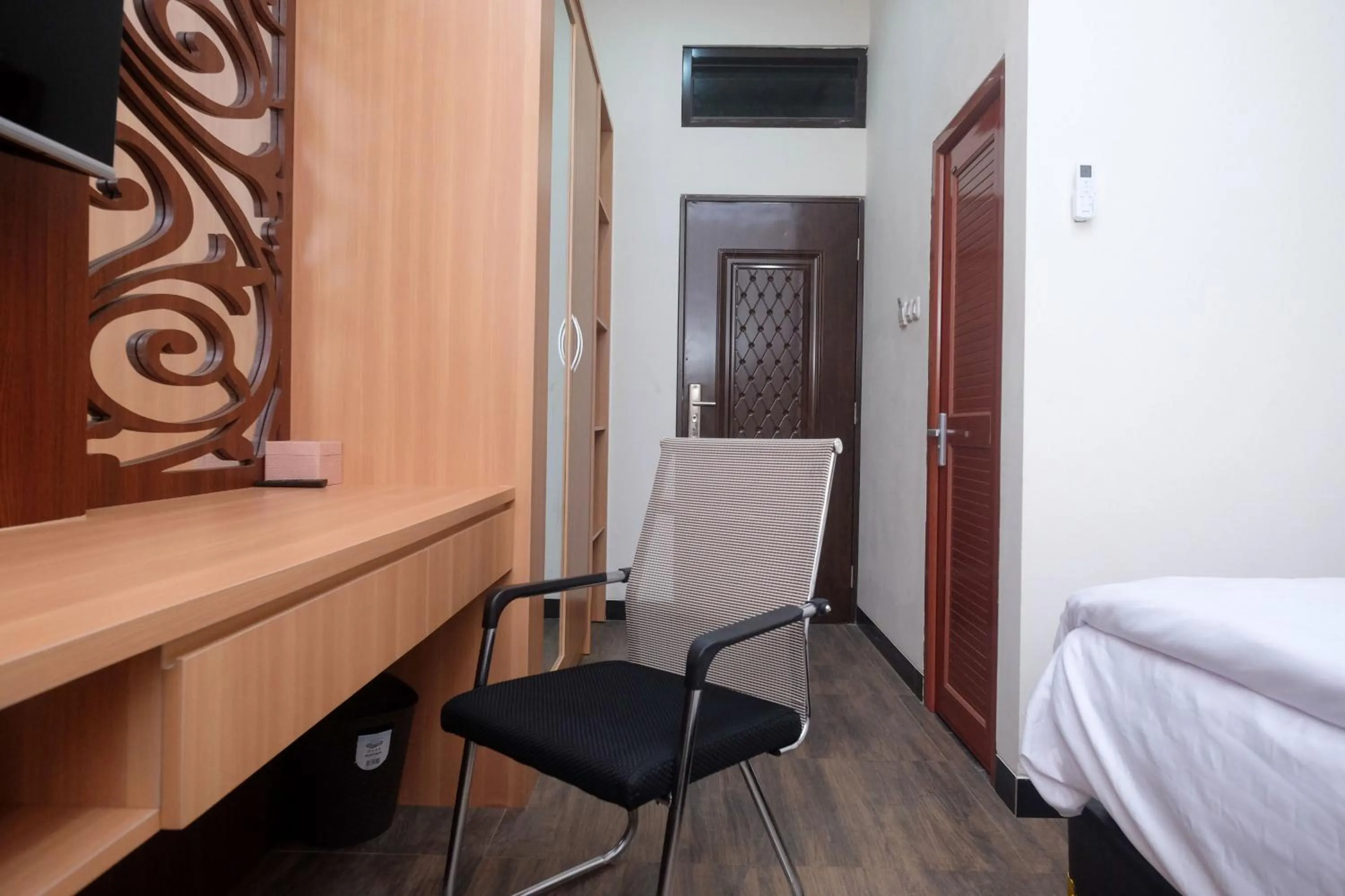 Seating area, Bed in Urbanview Grand Lotus Hotel by RedDoorz