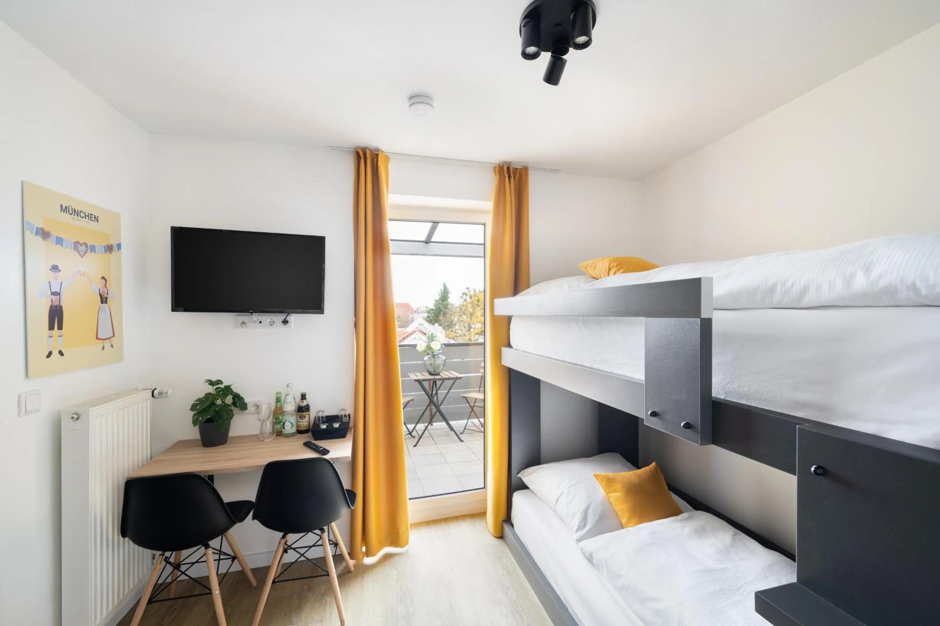 TV and multimedia, Bed in Homaris Apartments München Laim