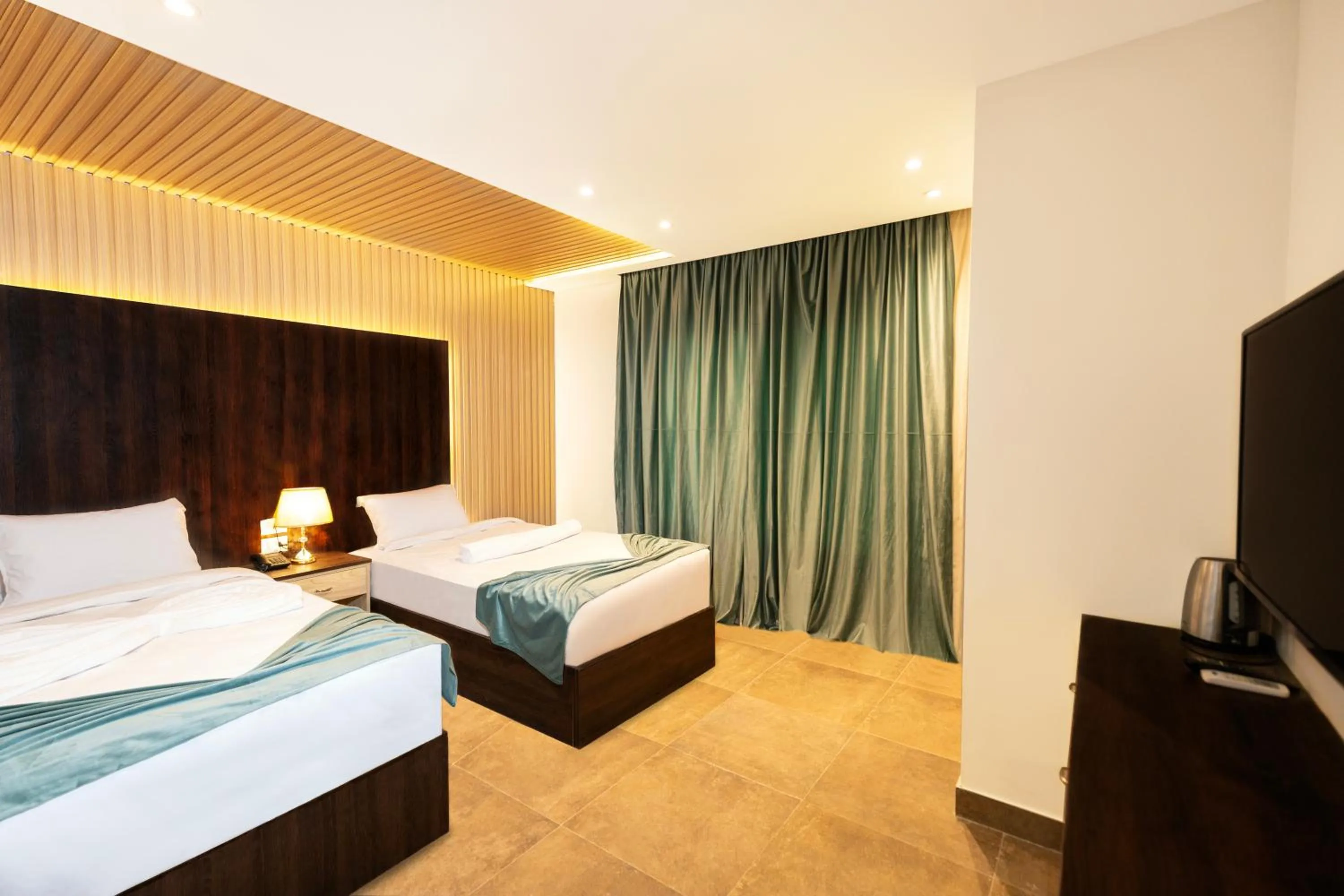 Communal lounge/ TV room, Bed in Blue Pyramids Eyes Hotel