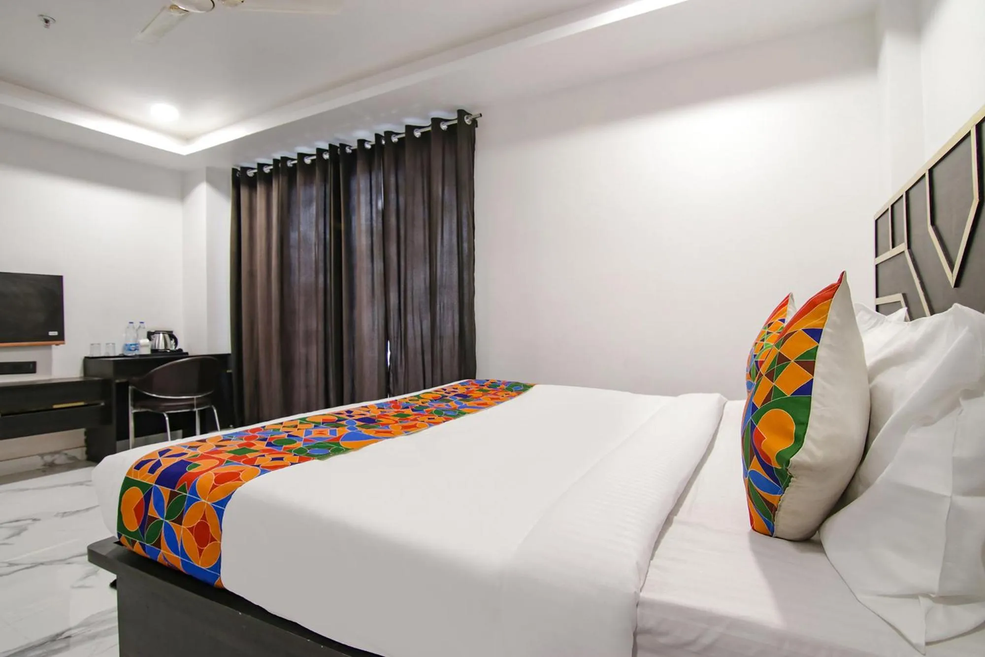 Bed in FabHotel Sky Suites Karkardooma