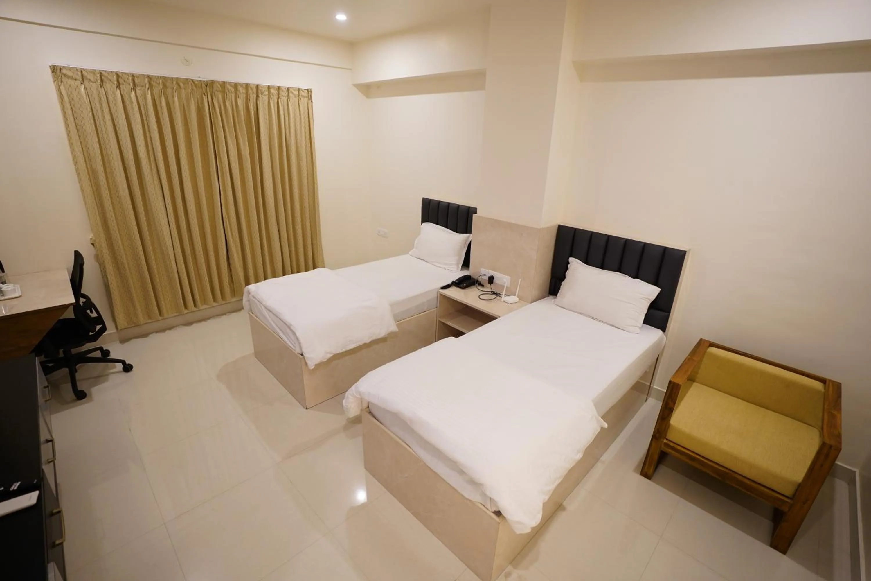Bed in DrizzleDrop Inn Chennai