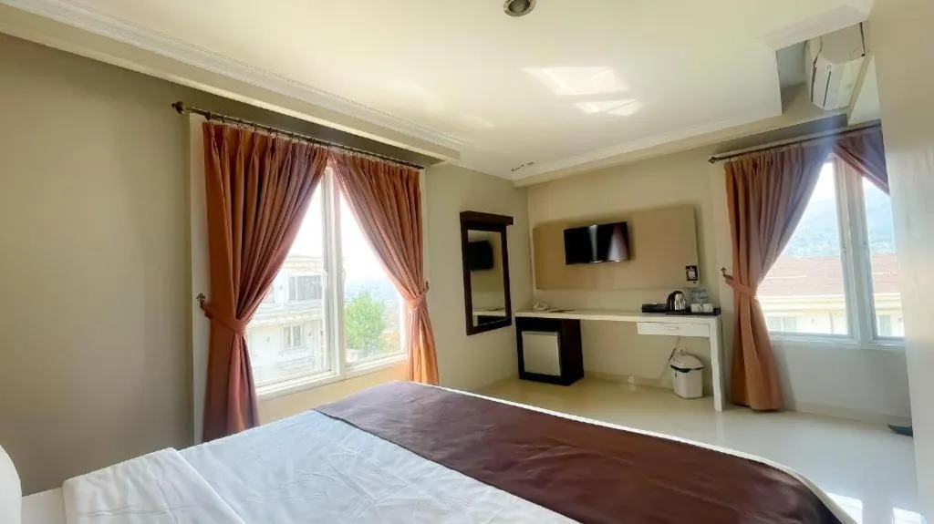 Bed in Rizen Premiere Hotel