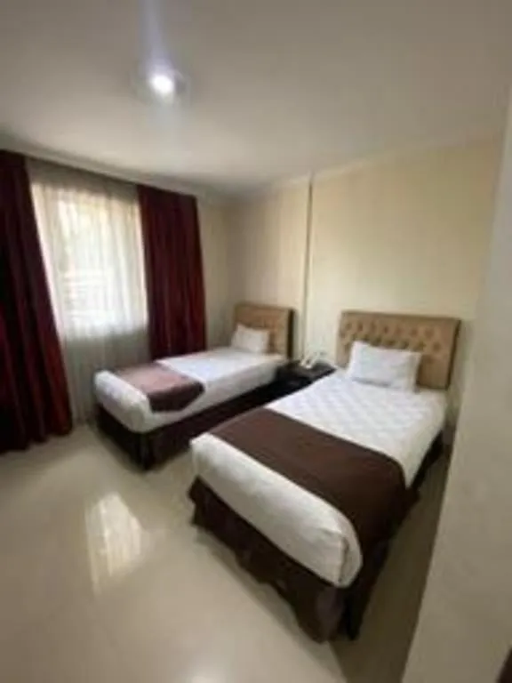 Bed in Rizen Premiere Hotel