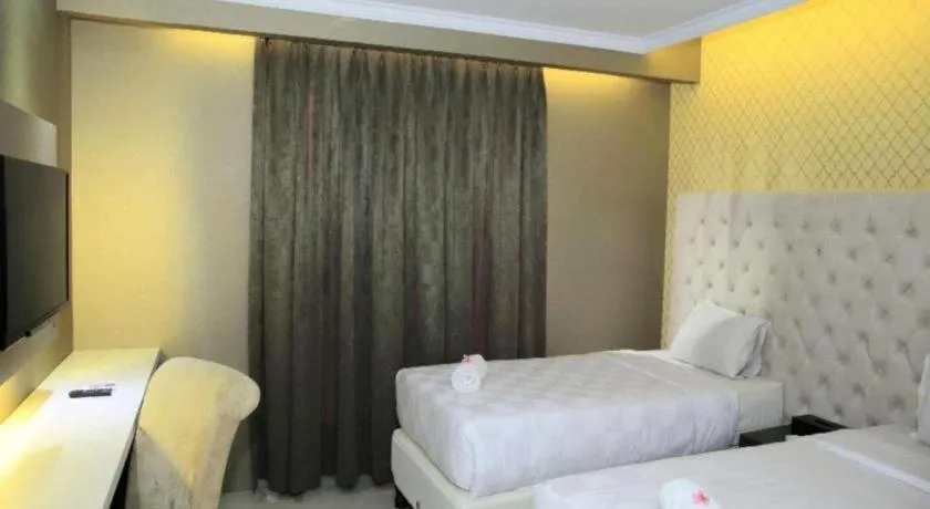 Bed in Rizen Premiere Hotel