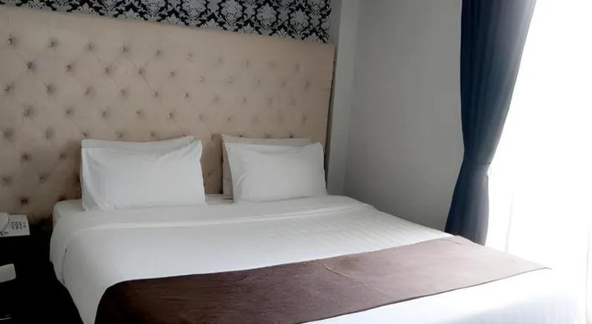 Bed in Rizen Premiere Hotel