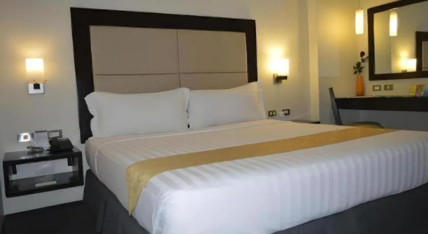 Bed in Mallberry Suites Business Hotel