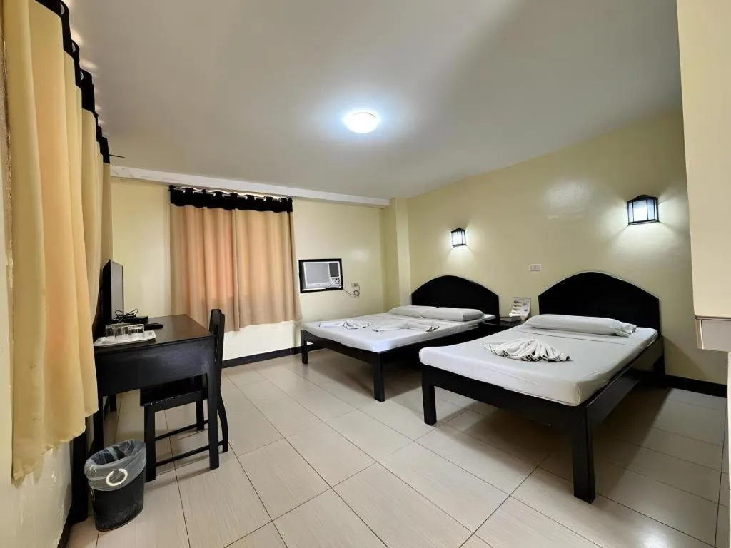 Bed in Sampaguita Suites Plaza Garcia