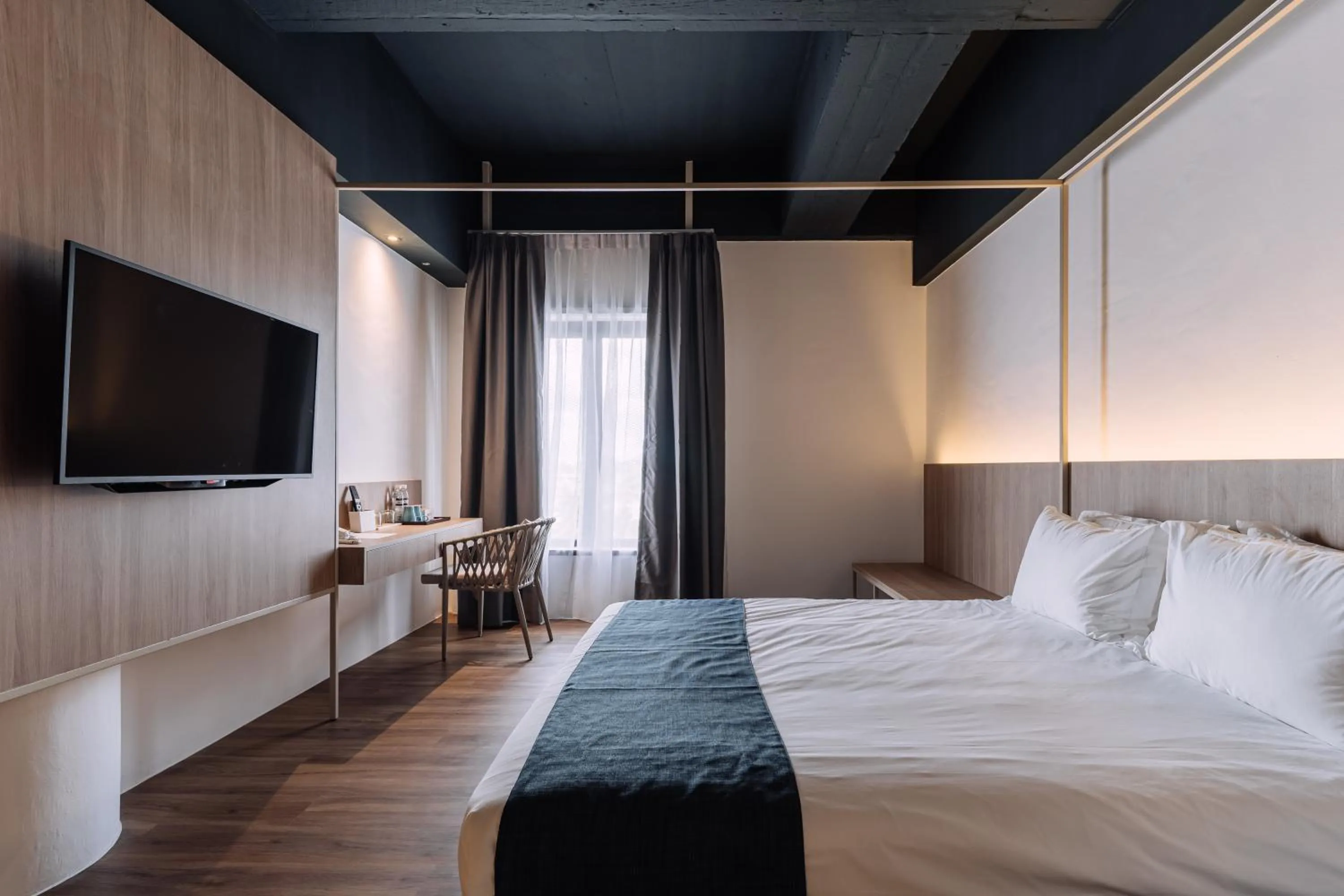 Bed in Impiana by Roxy Hotel